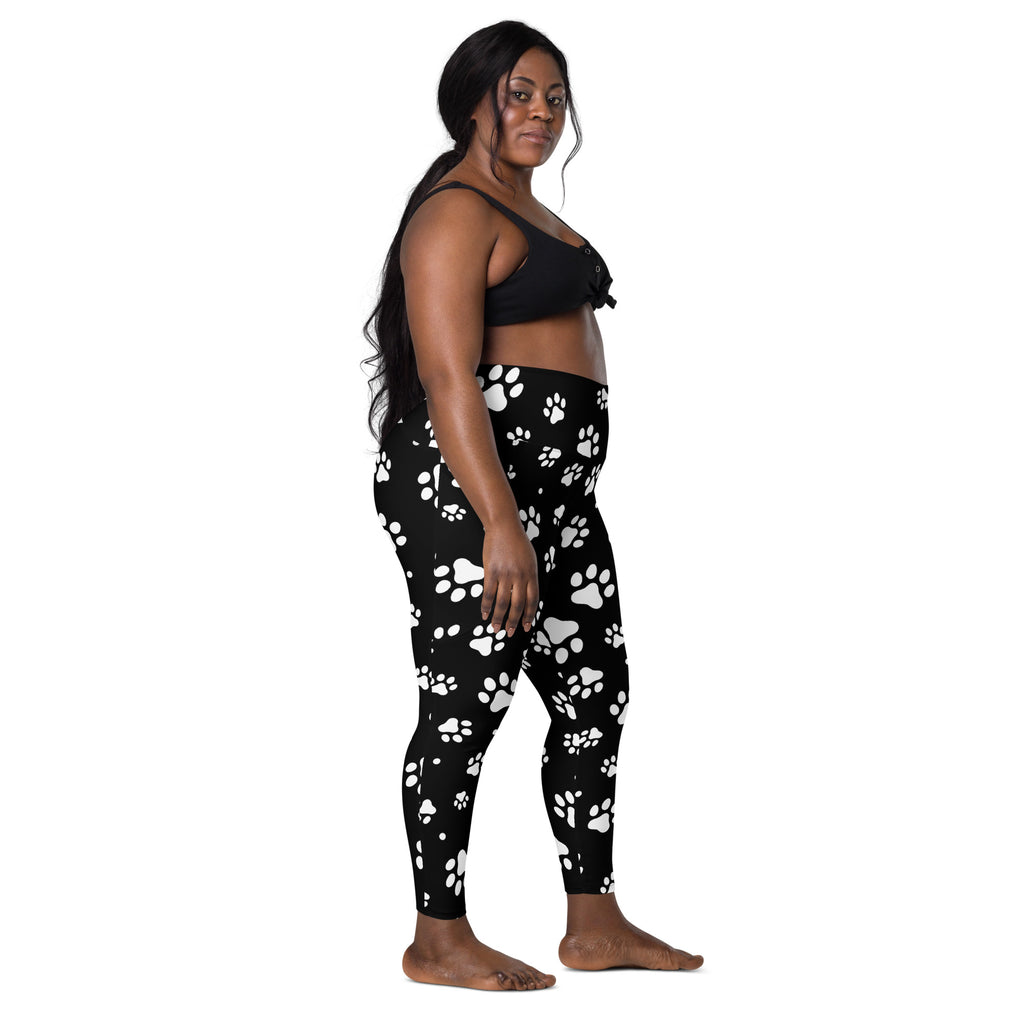 Black high-waisted women’s paw print yoga leggings with pockets featuring a soft compression fabric and white paw prints