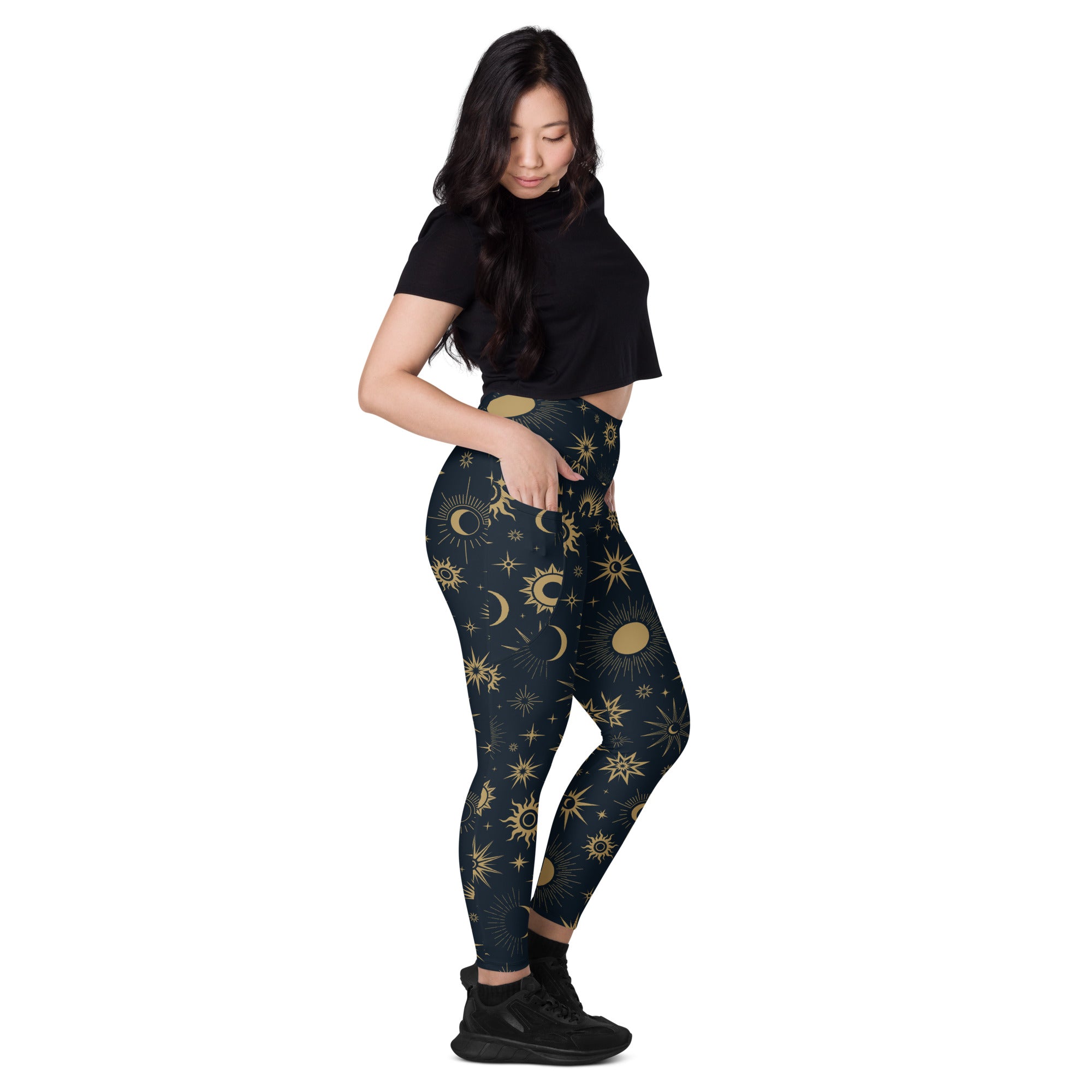 Dark blue high-waisted women’s celestial sun and moon yoga leggings with vibrant gold pattern and pockets