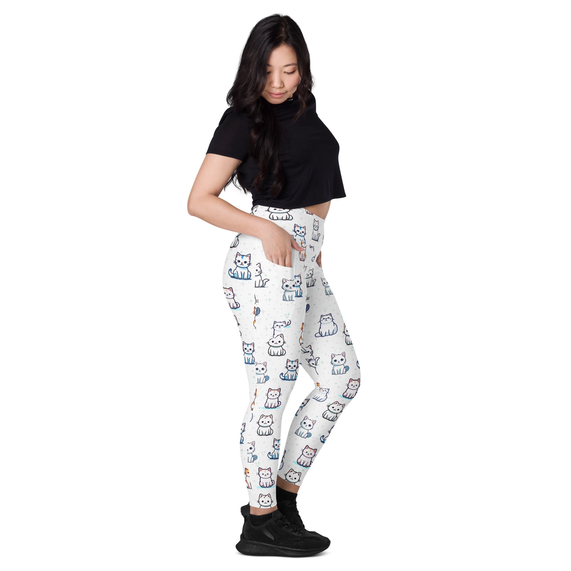 White high-waisted yoga leggings with soft compression and pockets featuring playful multicolored cartoon cats