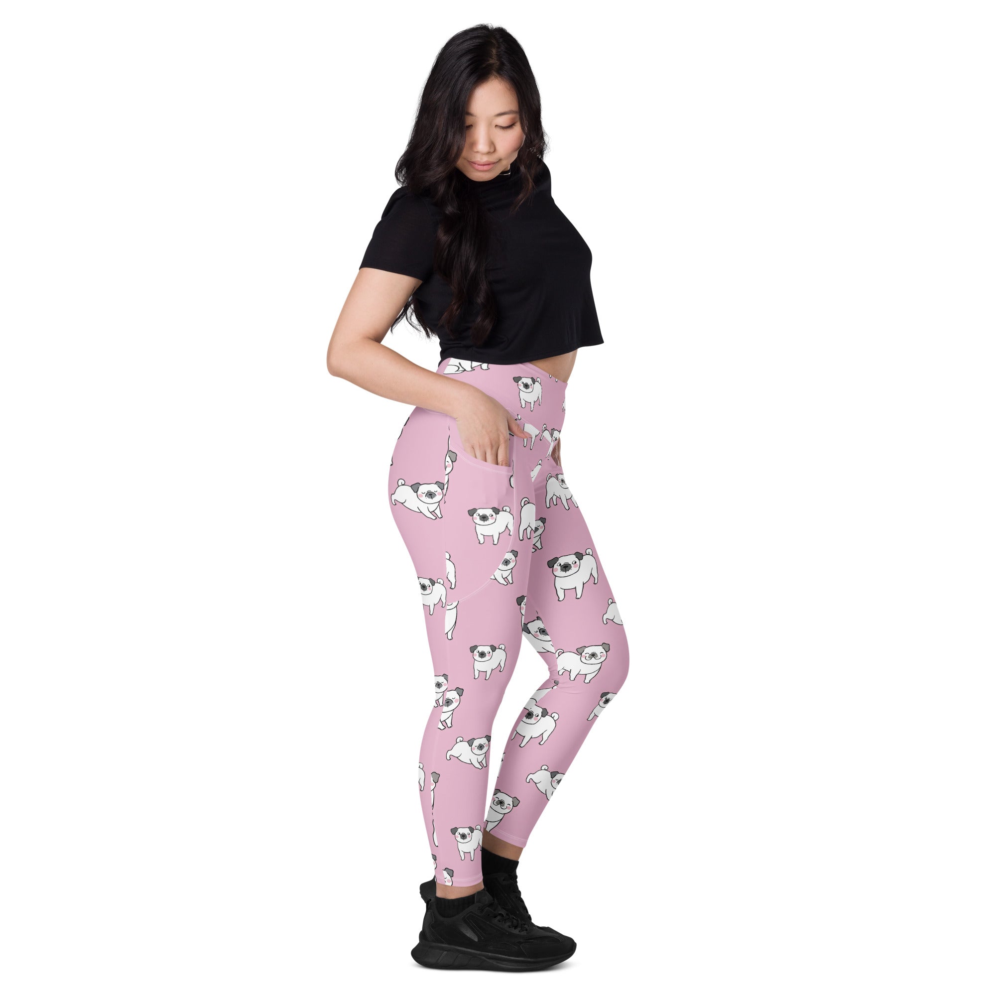 Women’s pink high waisted yoga leggings with pockets featuring a playful white cartoon pug pattern and soft compression