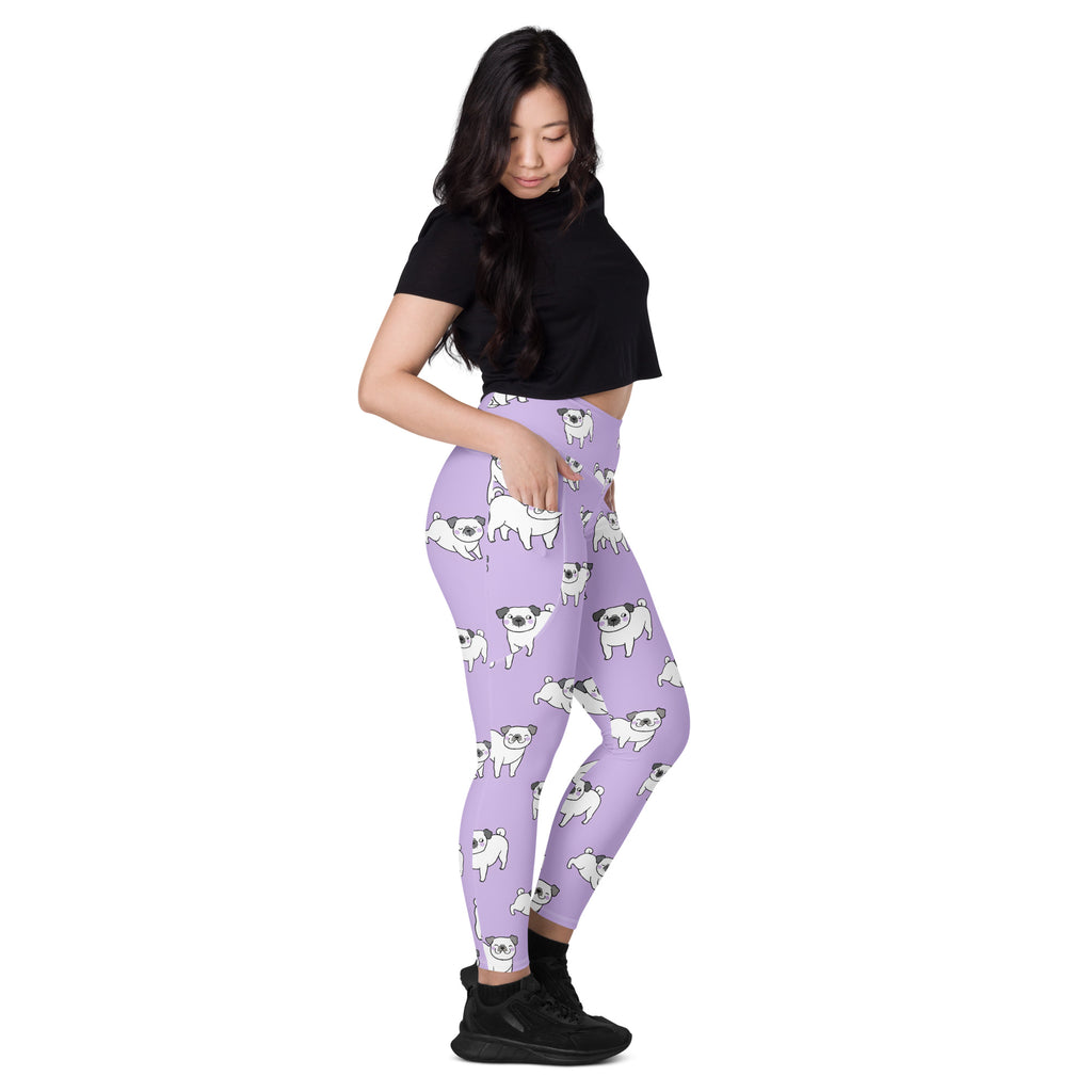 Women’s purple high-waisted yoga leggings with pockets featuring white cartoon pug pattern and soft compression fabric