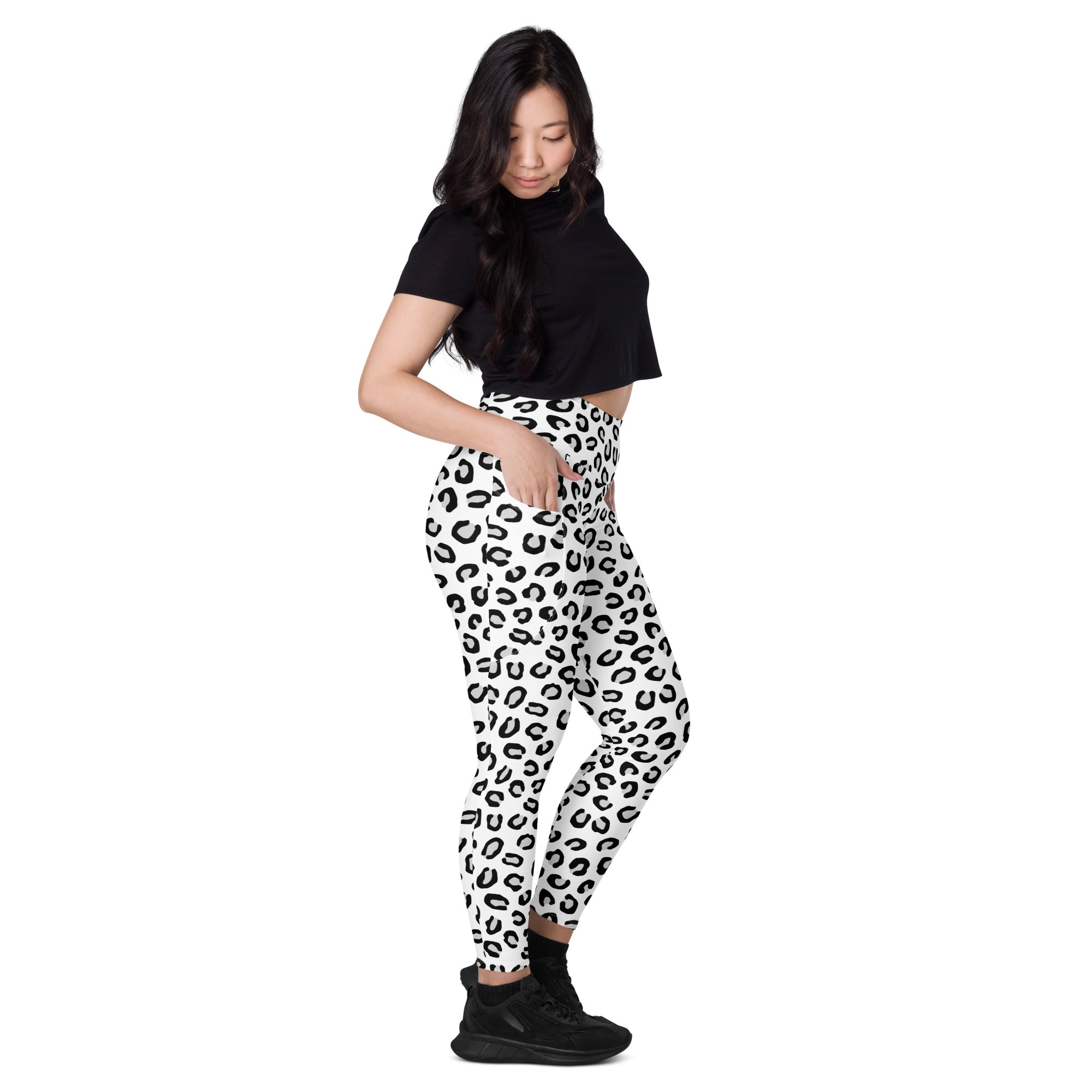 Black and white leopard print women’s high-waisted yoga leggings with pockets soft compression active pants front view