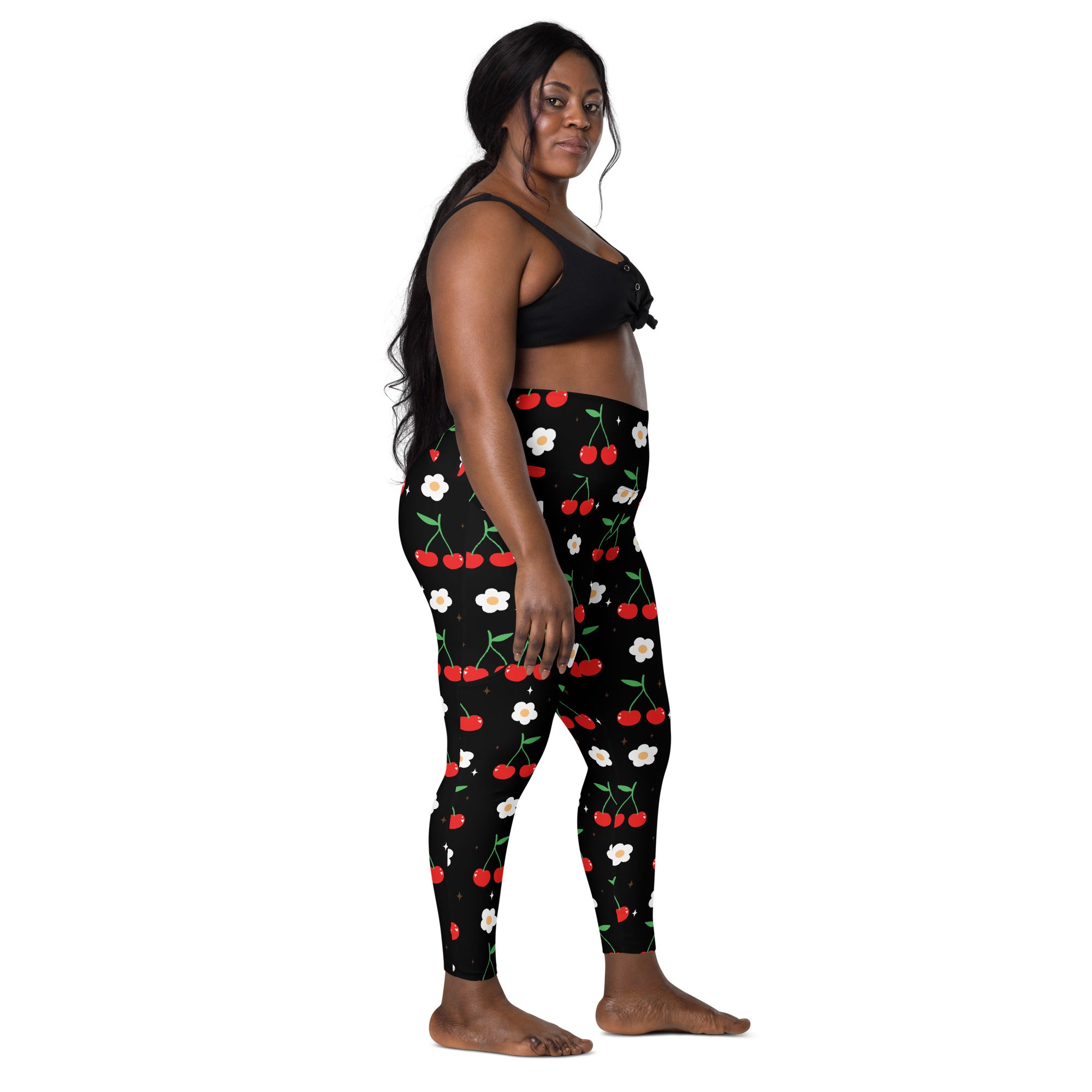 Women’s black high-waisted yoga leggings with soft compression featuring red cherry and white flower pocket print