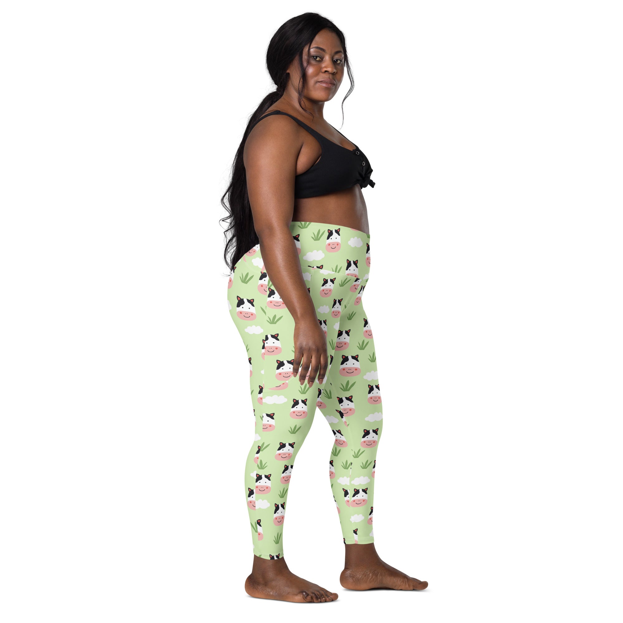 Women’s light green high-waisted cute cow yoga leggings with pockets featuring cartoon cow faces and soft compression