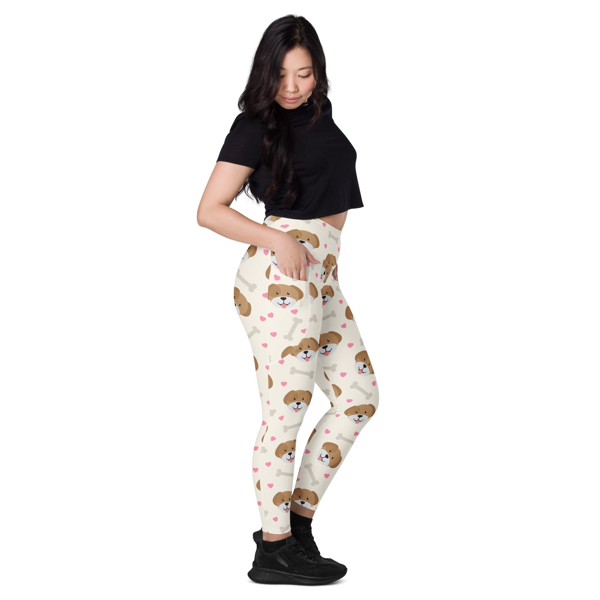 Cream-colored women’s cute dog yoga leggings with pockets featuring brown puppy faces pink hearts and white bones design