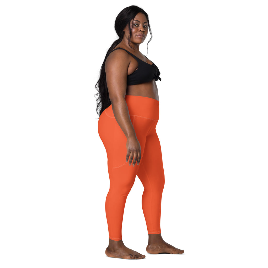 Women’s bright orange high-waisted yoga leggings with pockets made of soft compression fabric for active wear