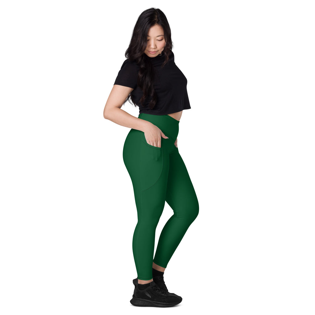 Women’s dark green high-waisted yoga leggings with soft compression fabric and side pockets for active wear