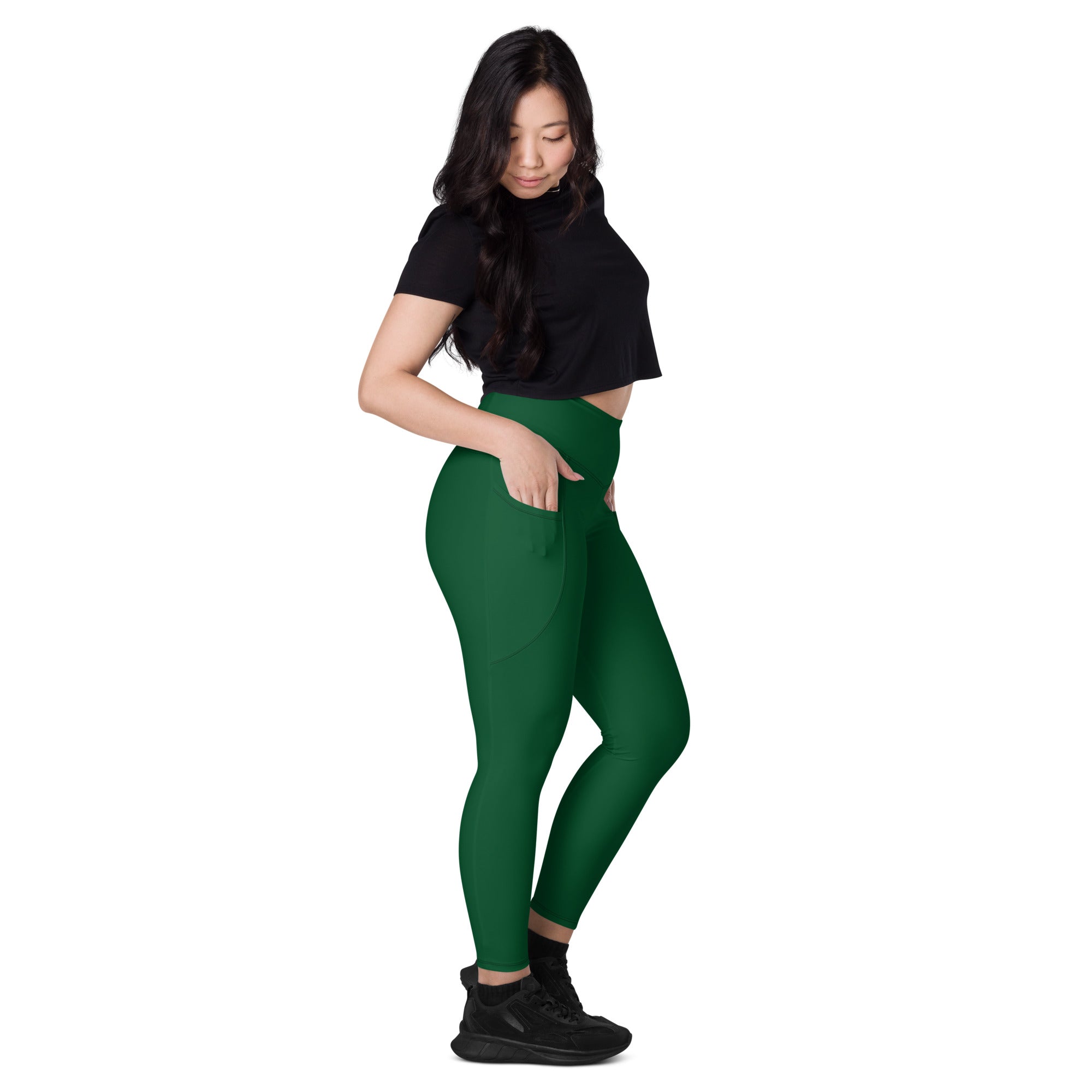 Women’s dark green high-waisted yoga leggings with soft compression fabric and side pockets for active wear