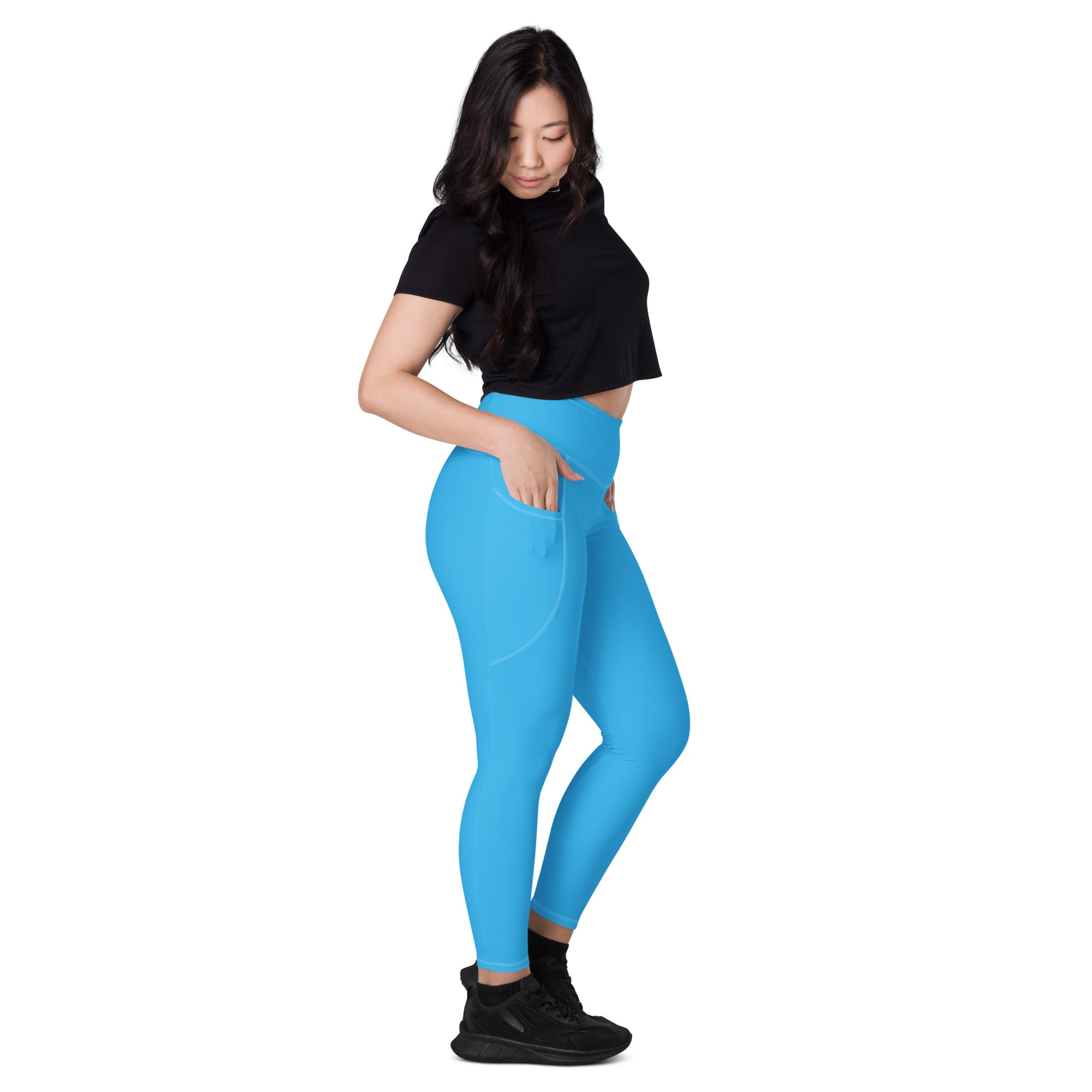 Bright blue women’s high-waisted yoga leggings with soft compression fabric and side pockets for activewear use