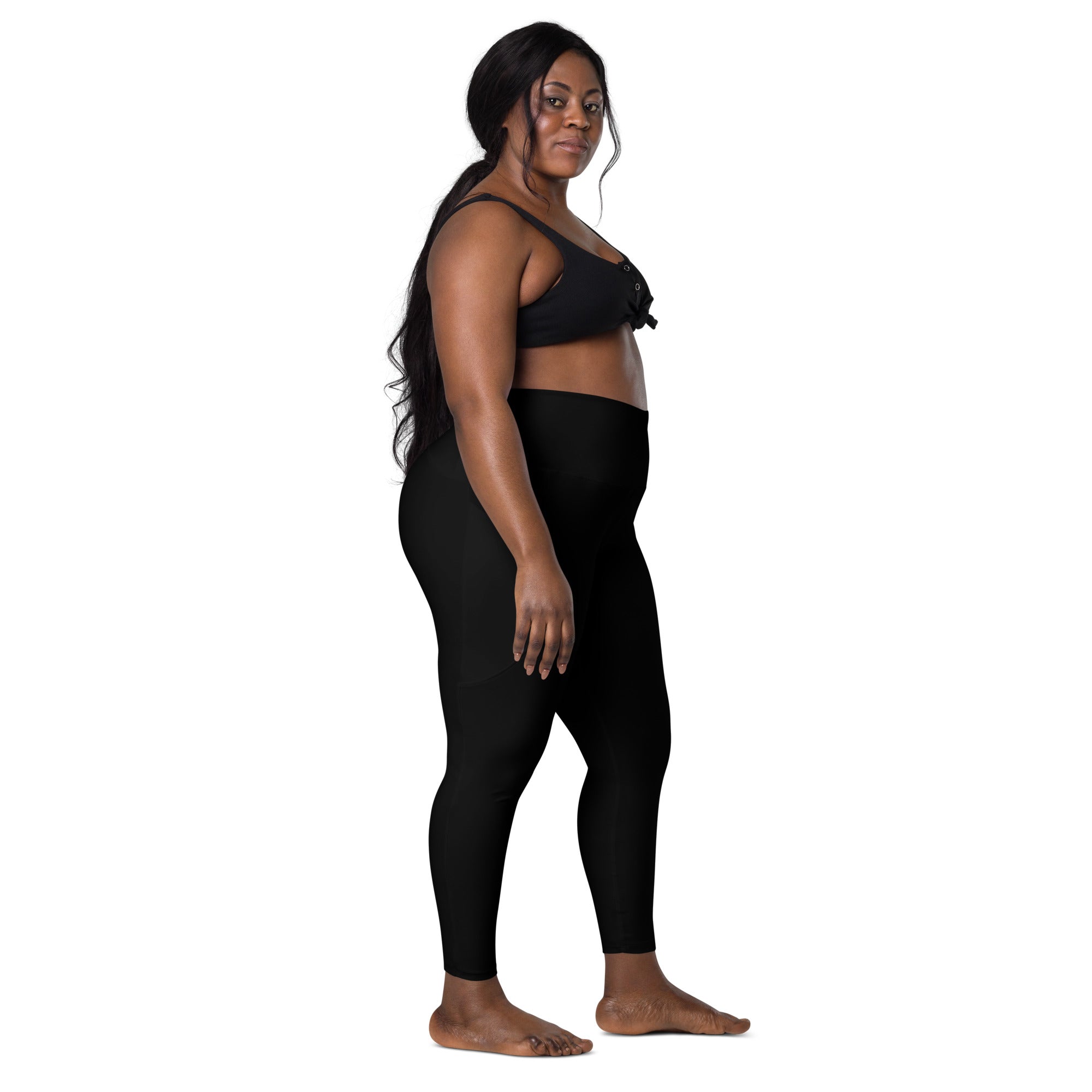Women’s black high-waisted seamless yoga leggings with pockets and matching black sports bra with bow details