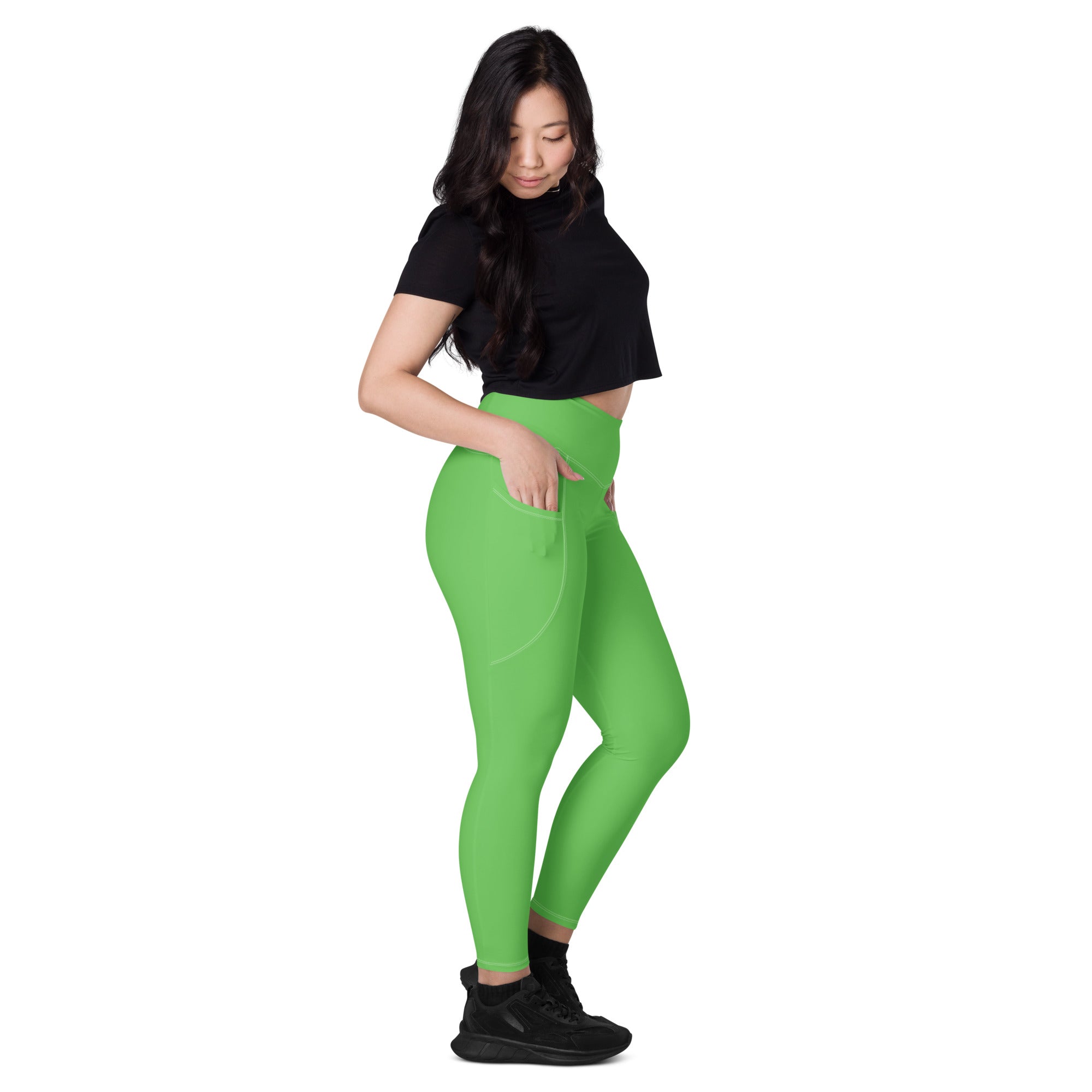 Women’s green high-waisted yoga leggings with pockets soft compression and sleek form-fitting design