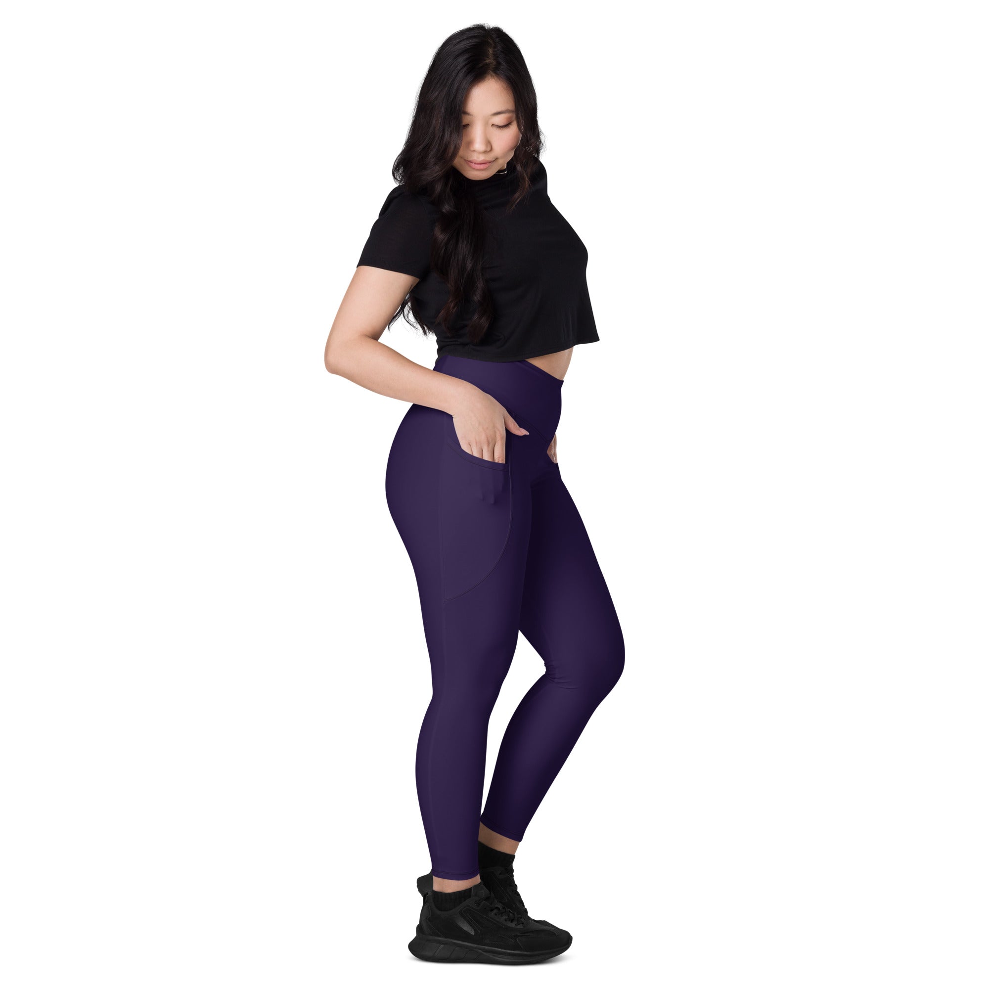 Women’s dark purple high-waisted yoga leggings with soft compression material and side pockets for active use