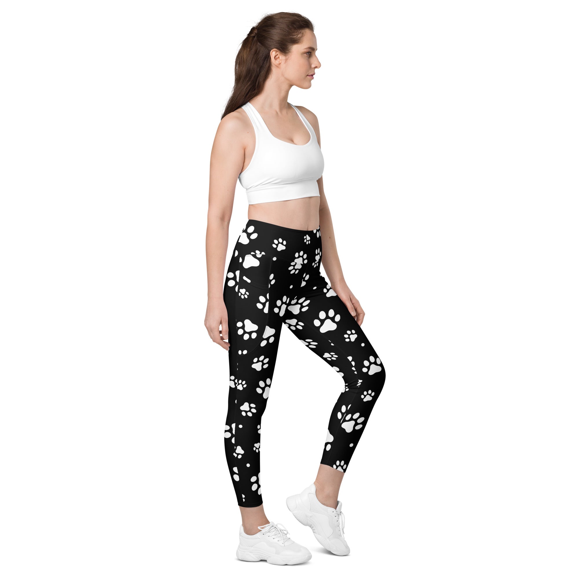 Women’s black high waisted yoga leggings with white paw print pattern soft compression fabric and pockets
