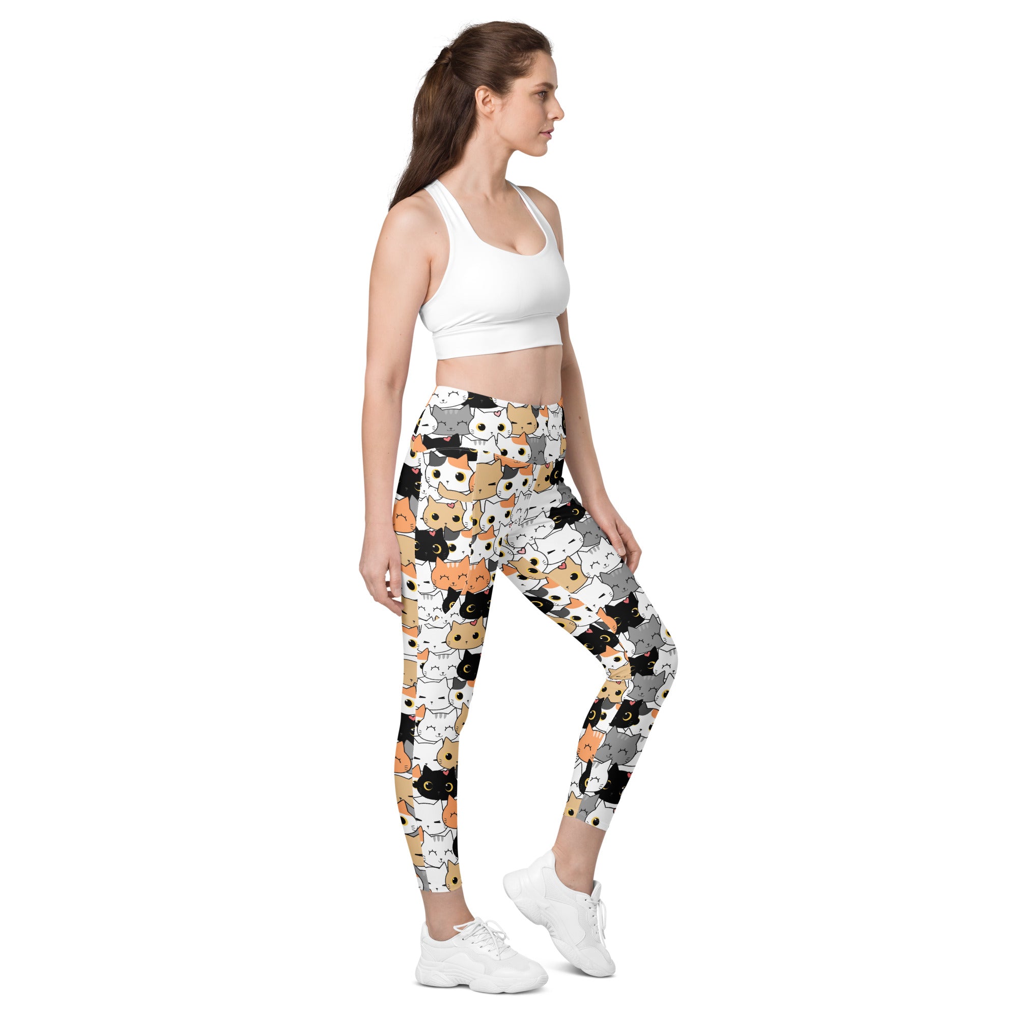 Women’s high-waisted soft compression yoga leggings with pockets featuring white and multicolored cartoon cat patterns