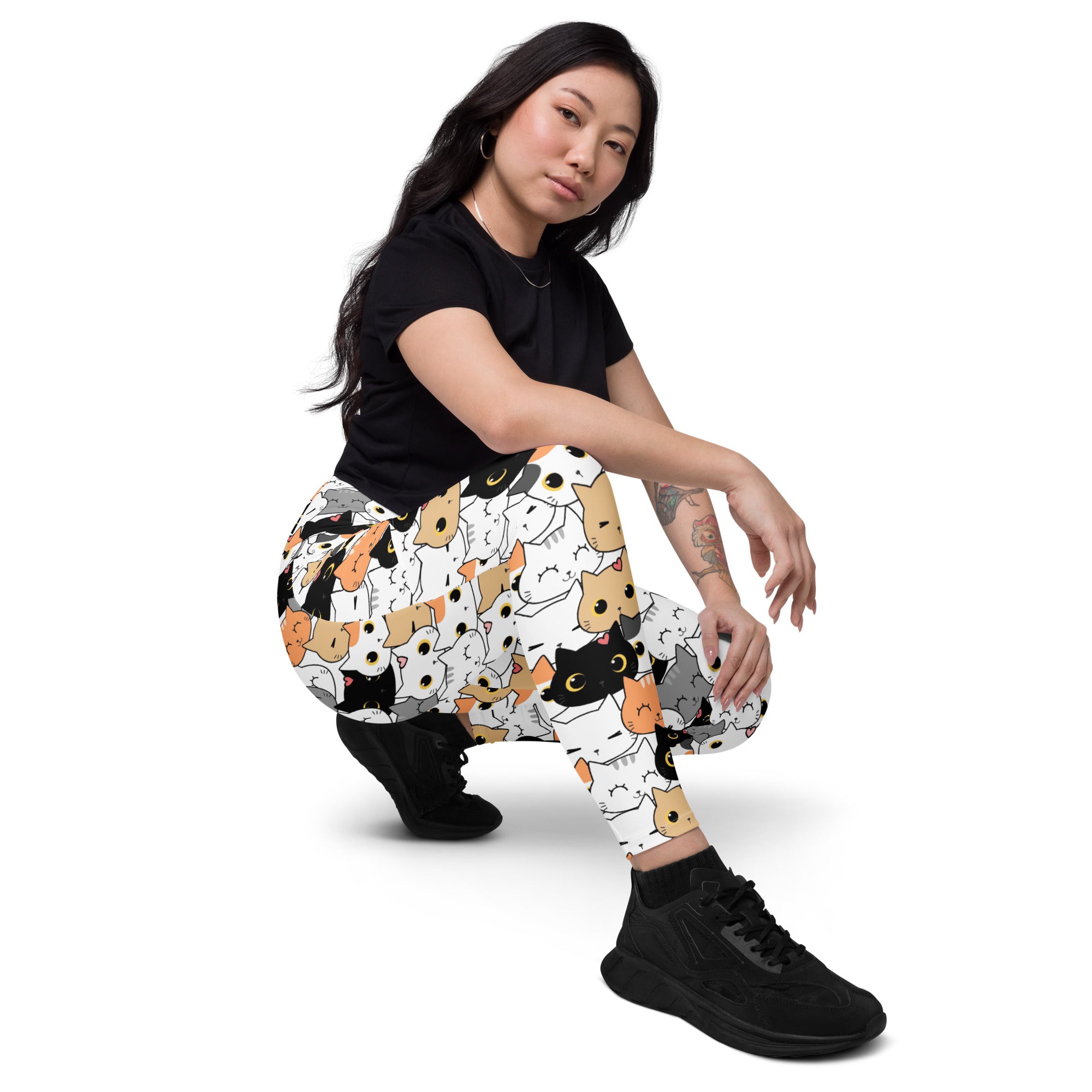 White women’s high-waisted cat face yoga leggings with pockets featuring playful black orange and gray cartoon cats