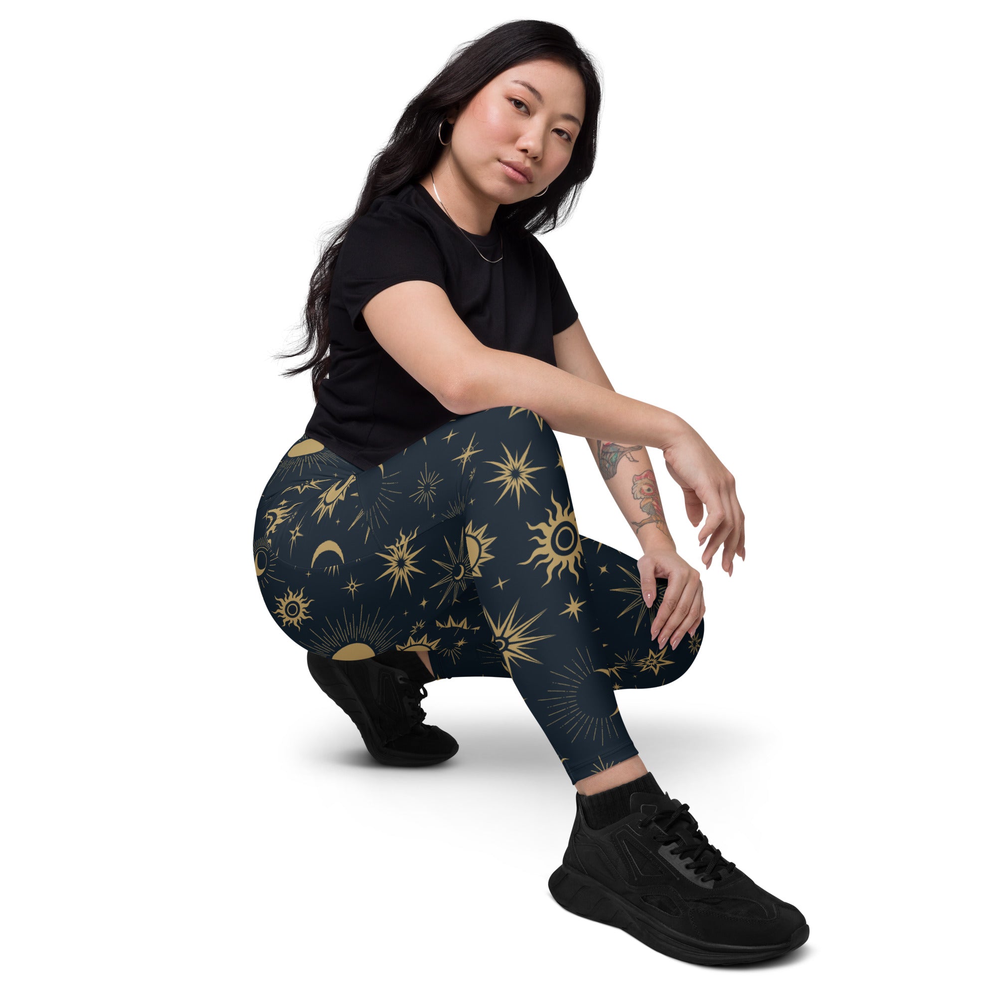 Dark blue high waisted women’s yoga leggings with pockets featuring vibrant gold celestial suns moons and stars pattern