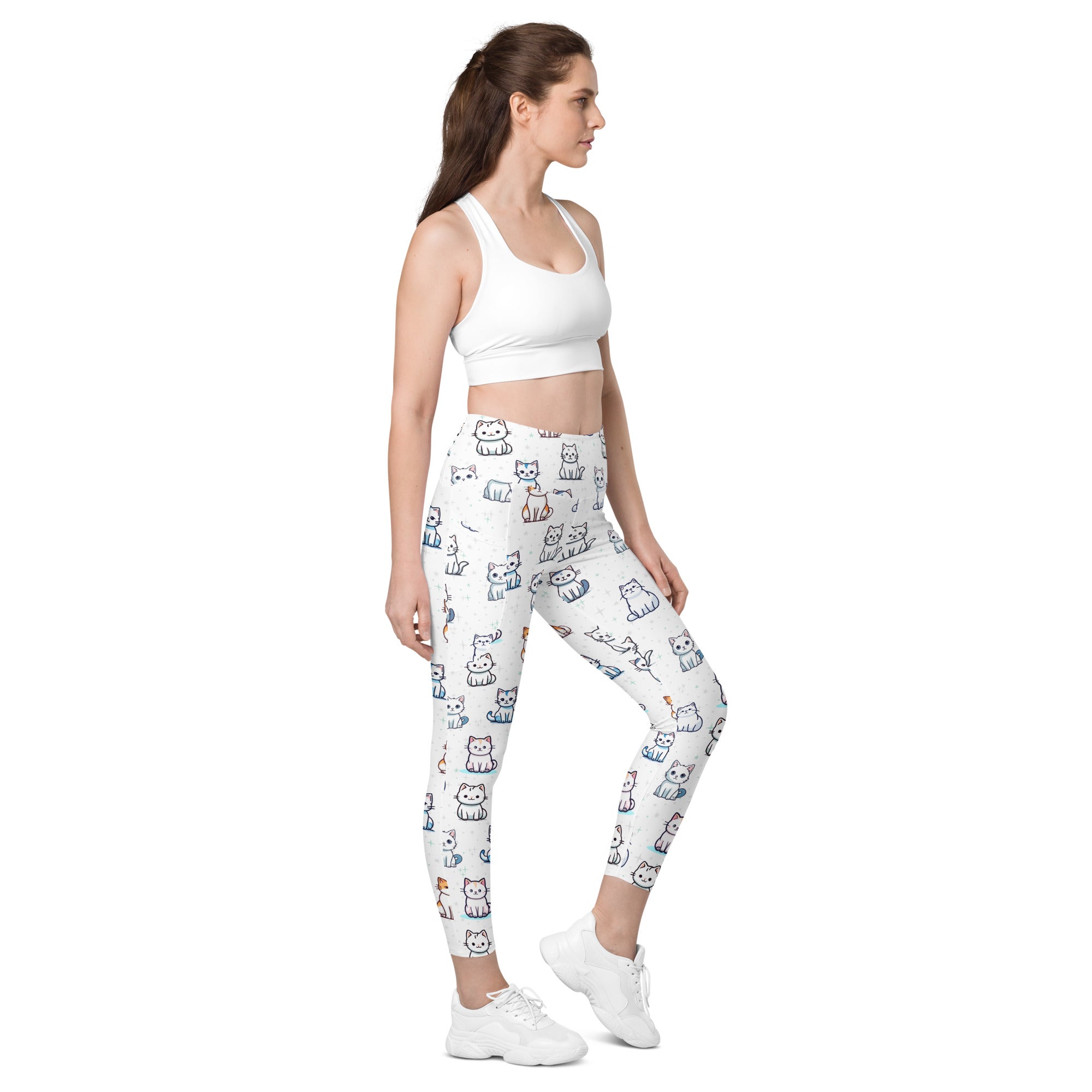 White women’s high-waisted yoga leggings with pockets featuring playful cartoon cats in various colors and poses