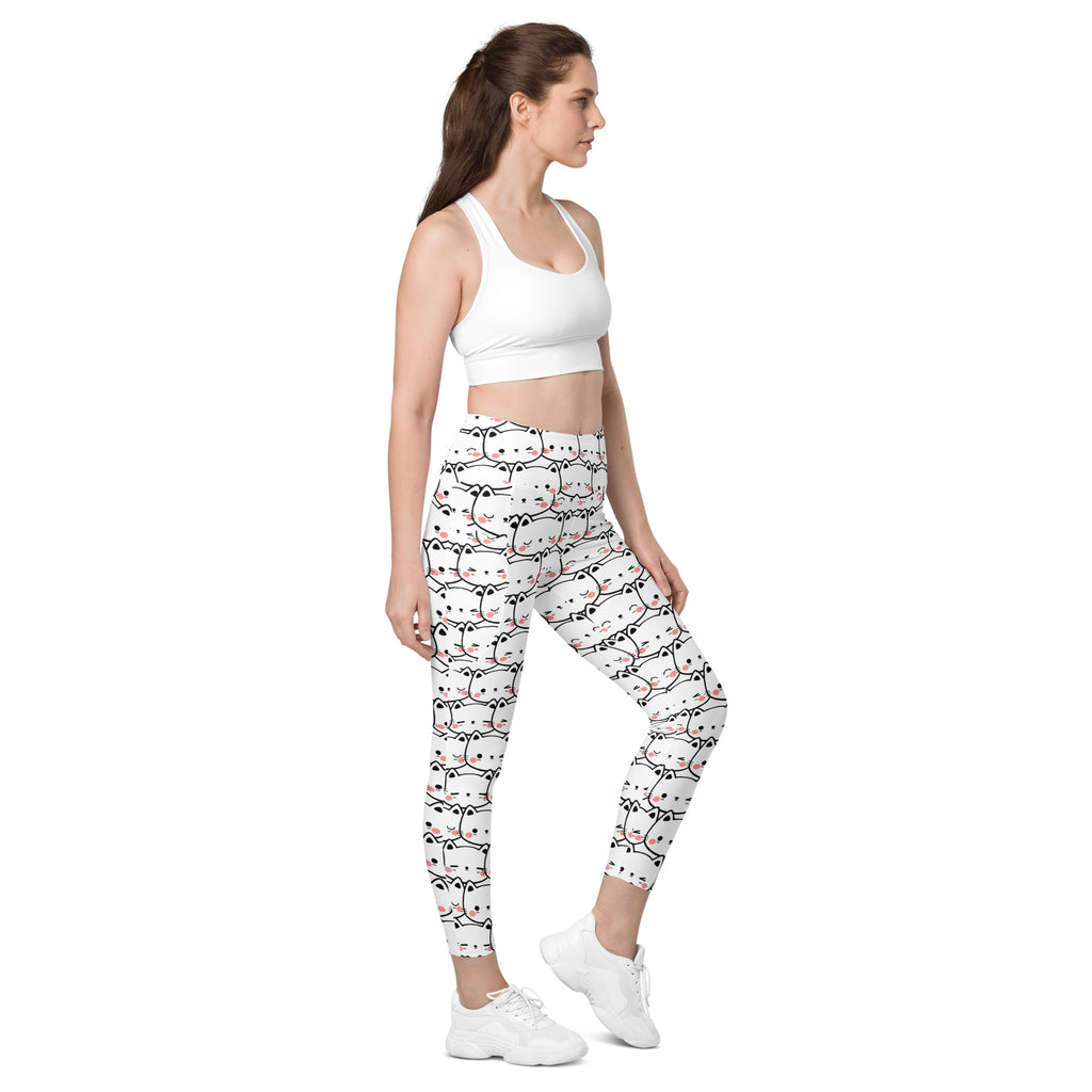 White high-waisted yoga leggings with soft compression and pockets featuring a kawaii black and pink cat face pattern