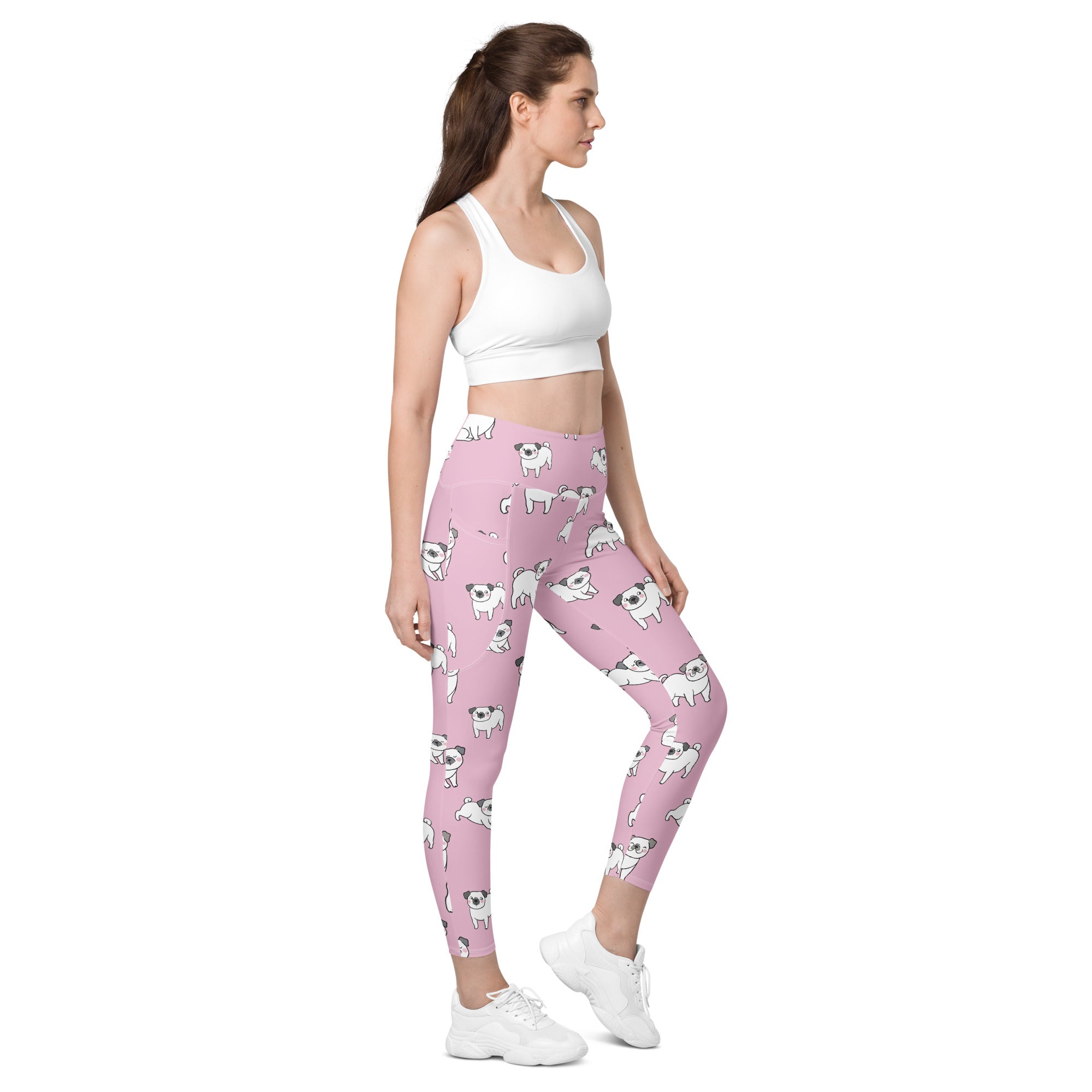 Women’s pink high waisted yoga leggings with soft compression and pockets featuring a playful white pug pattern