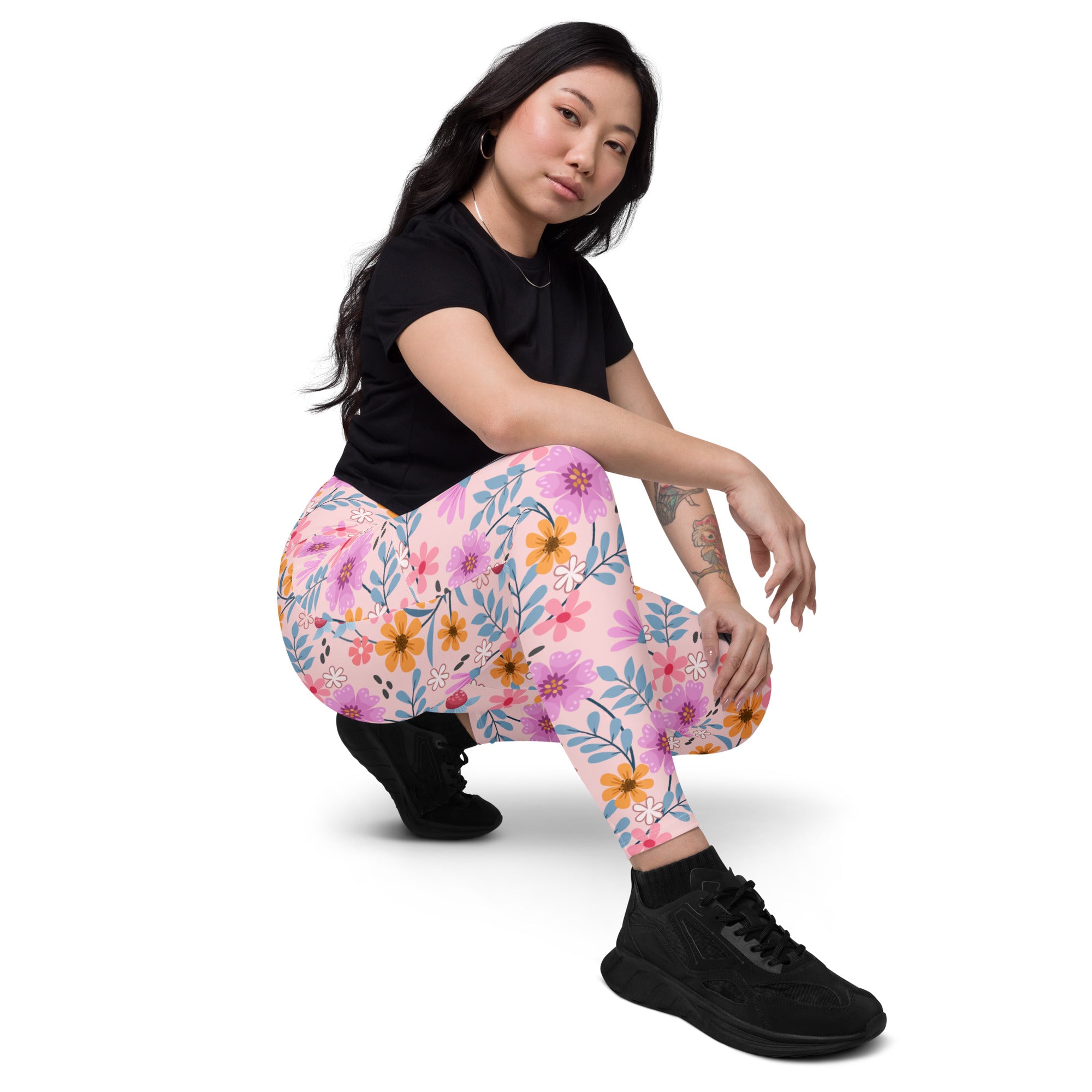 Women’s pink floral yoga leggings with pockets high waisted soft compression fabric and vibrant purple orange white flowers