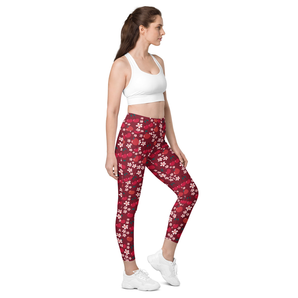 Women’s cherry blossom yoga leggings with pockets in red floral pattern on dark red background high-waisted soft compression