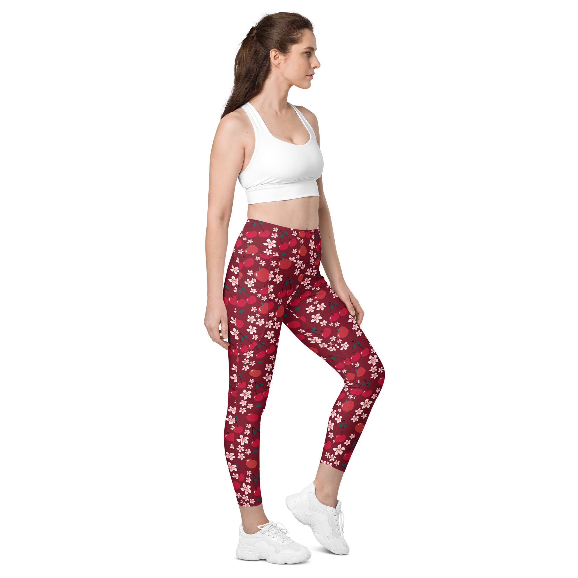 Women’s cherry blossom yoga leggings with pockets in red floral pattern on dark red background high-waisted soft compression
