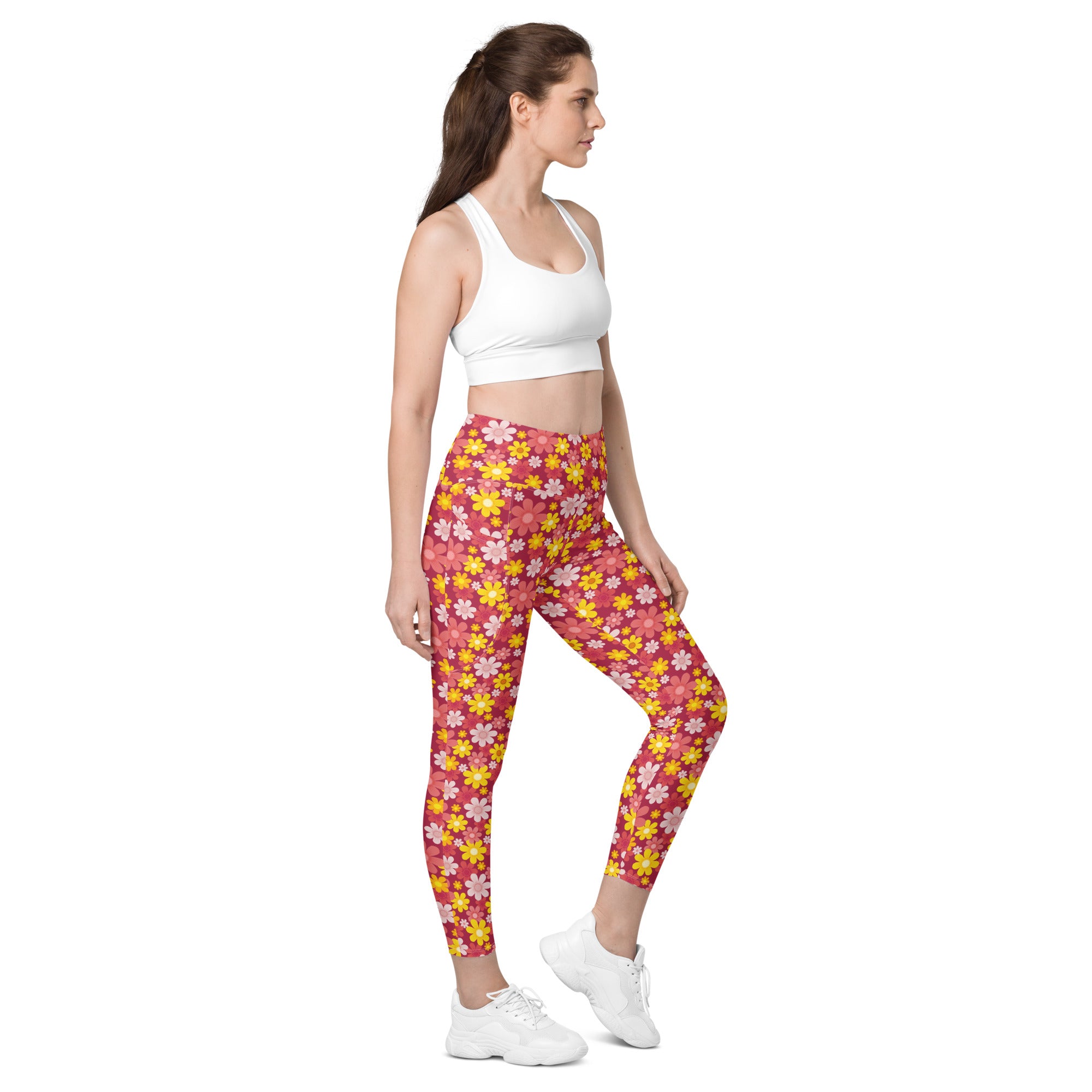 Women’s high-waisted red floral yoga leggings with pockets featuring snug floral-patterned pink and yellow soft compression design