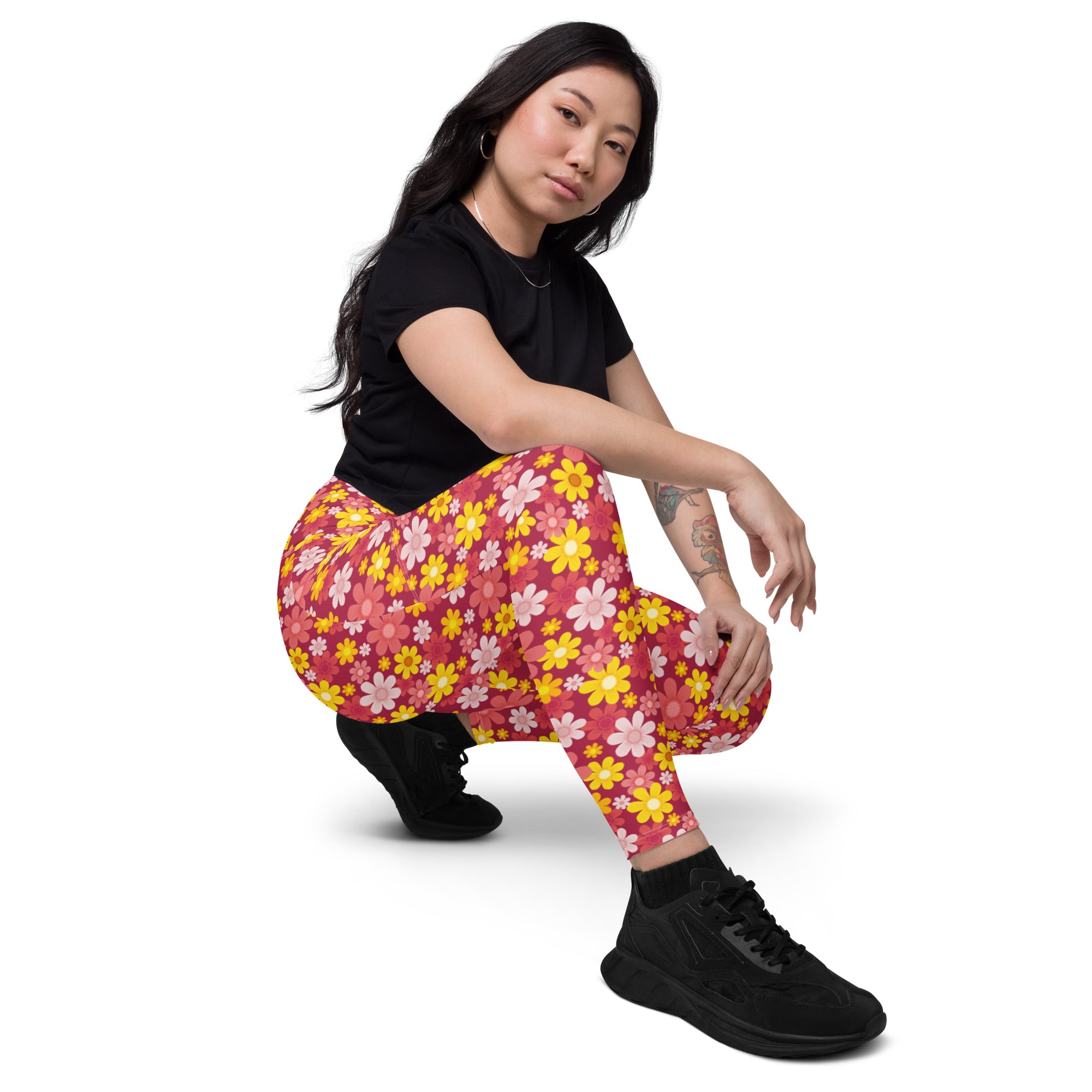 Women’s high-waisted red floral yoga leggings with pockets featuring vibrant pink fabric and yellow white daisy pattern