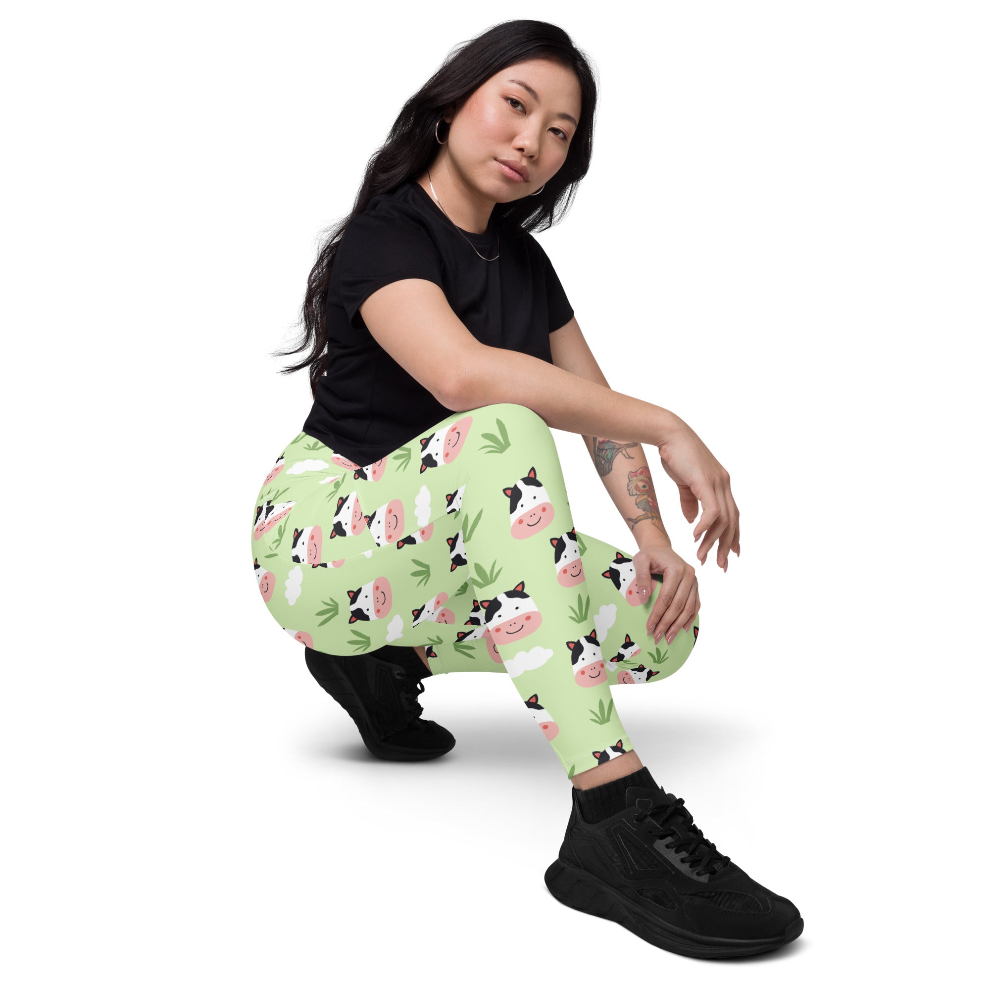 Women’s light green high-waisted yoga leggings with pockets featuring cartoon cows and bamboo leaves soft compression
