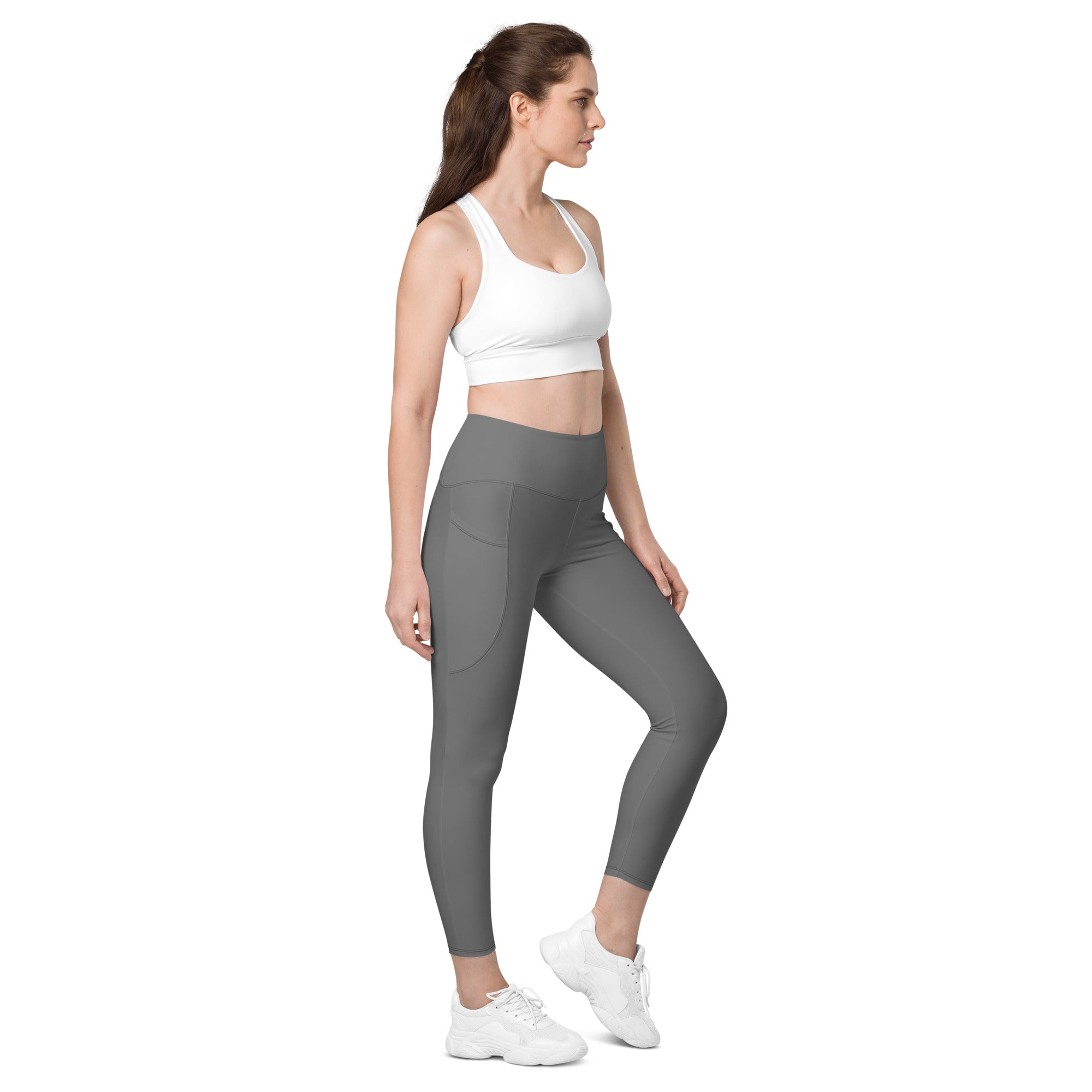Women’s gray high-waisted yoga leggings with soft compression fabric and subtle side pockets for active wear