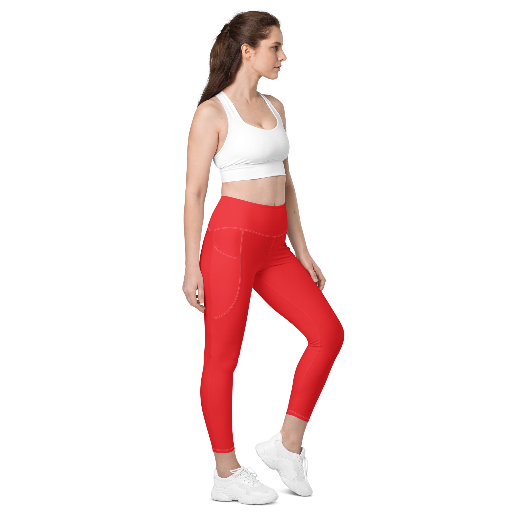 Women’s red high-waisted yoga leggings with soft compression fabric and subtle side pockets in a sleek design