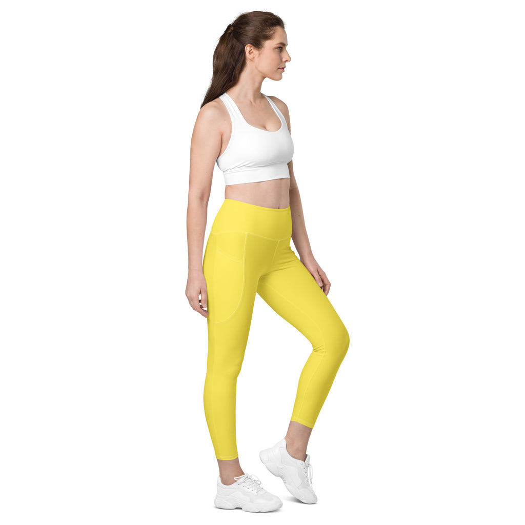 Women’s yellow high-waisted yoga leggings with pockets made from smooth, soft compression stretch fabric