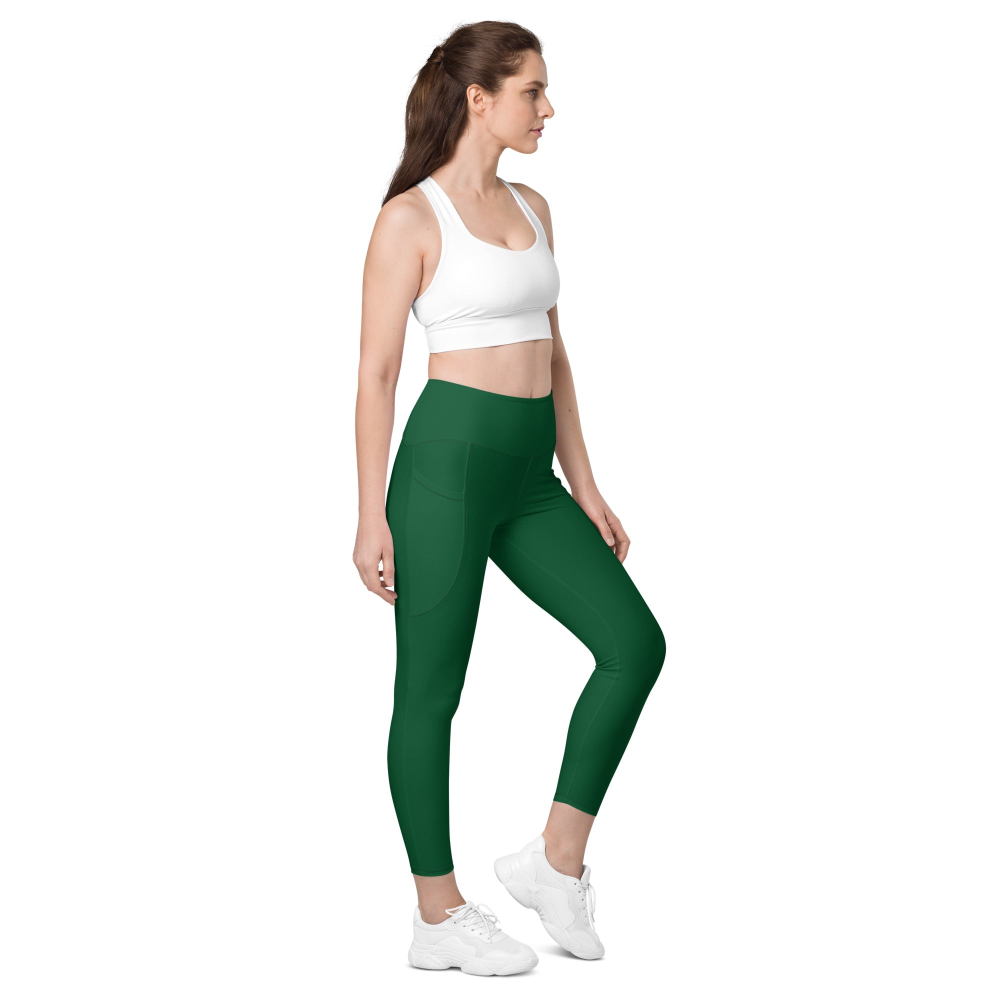 Women’s dark green high-waisted yoga leggings with pockets featuring soft compression and a sleek form-fitting design