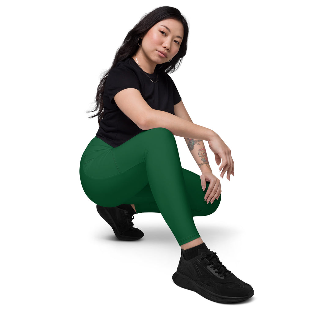 Women’s dark green high waisted yoga leggings with pockets made of soft compression fabric for active wear