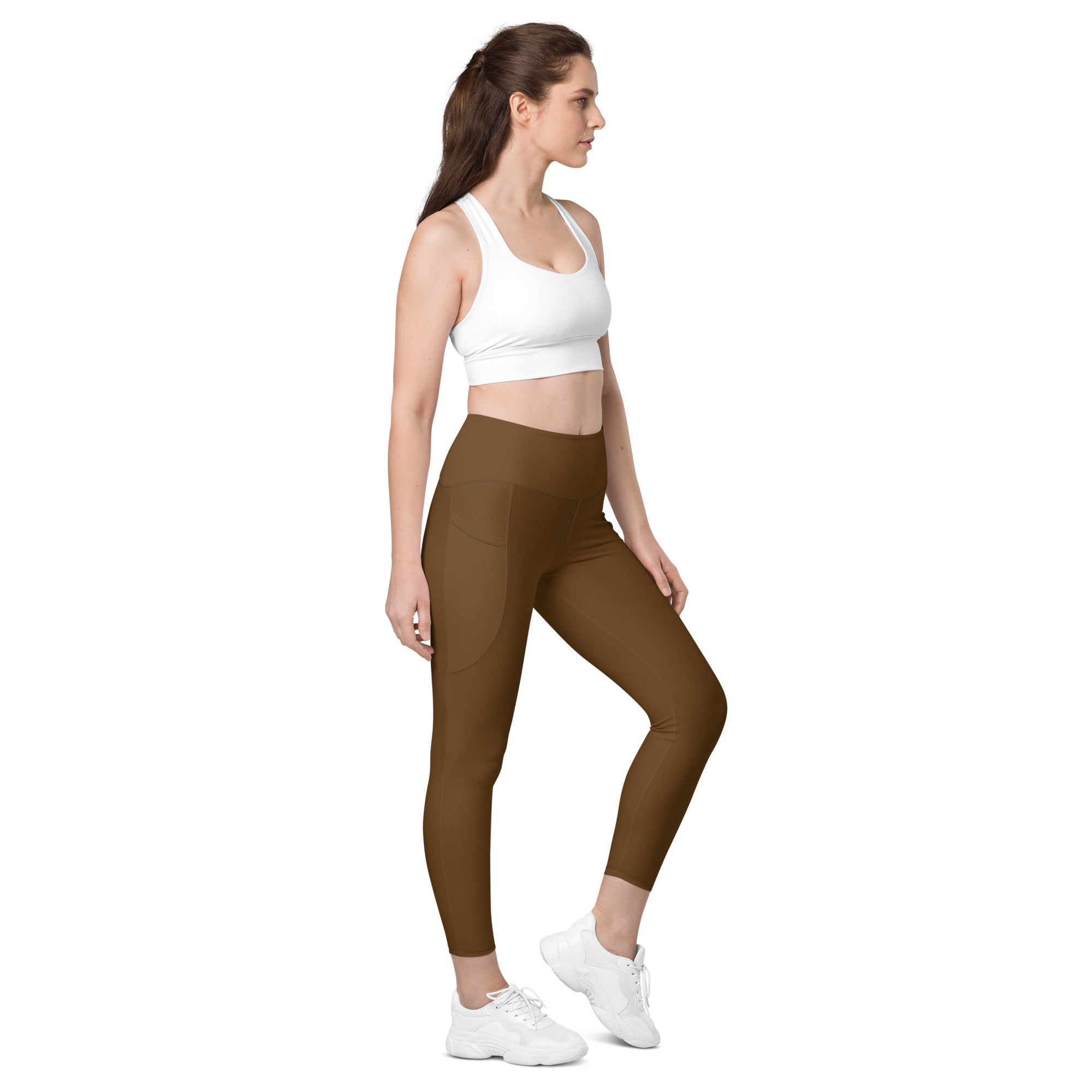 Women’s brown high waisted yoga leggings with pockets soft compression fabric and a sleek form fitting design