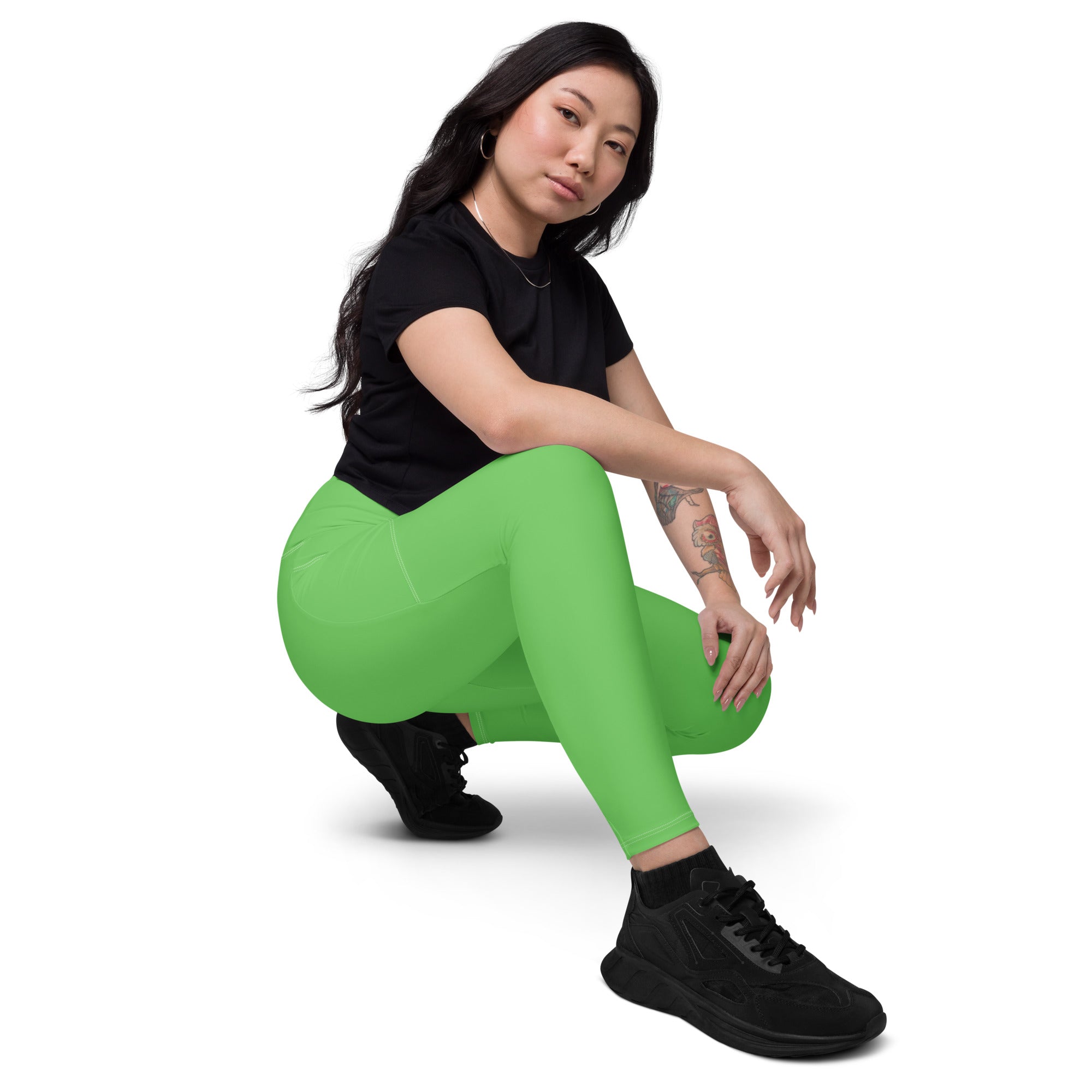 Vibrant lime green women’s high-waisted yoga leggings with pockets made of soft compression fabric for active wear