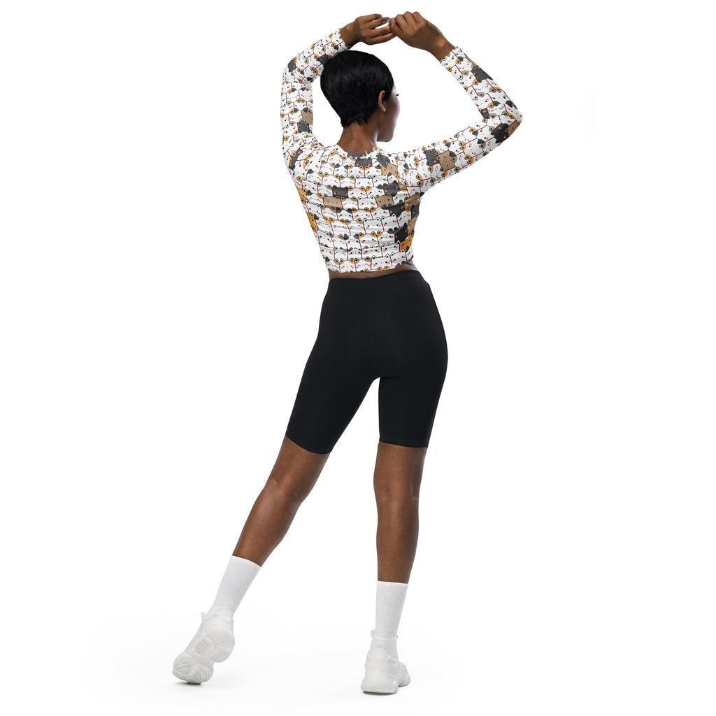 Women’s kawaii cat face long sleeve performance crop top with multicolored cats on white paired with black biker shorts