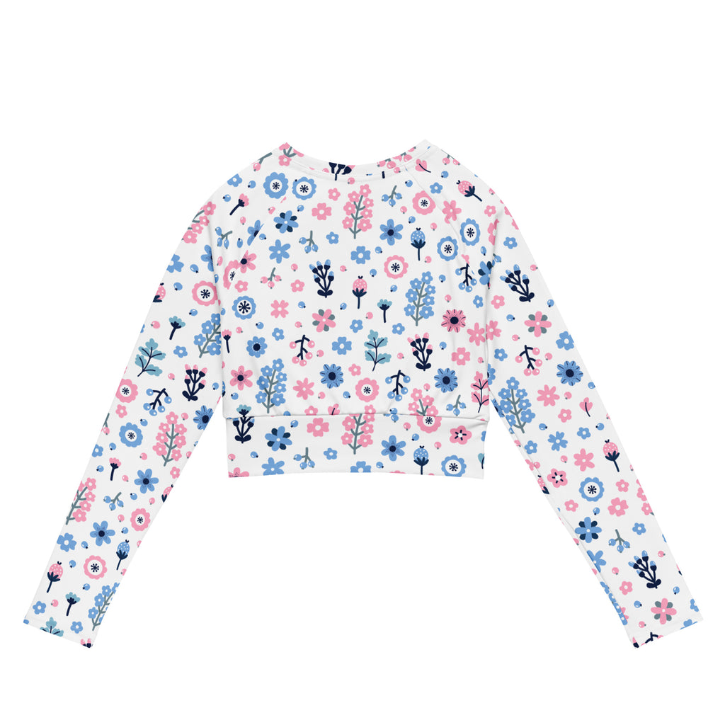 White long-sleeved crop top with pastel pink and blue floral print featuring black outlines for women’s activewear