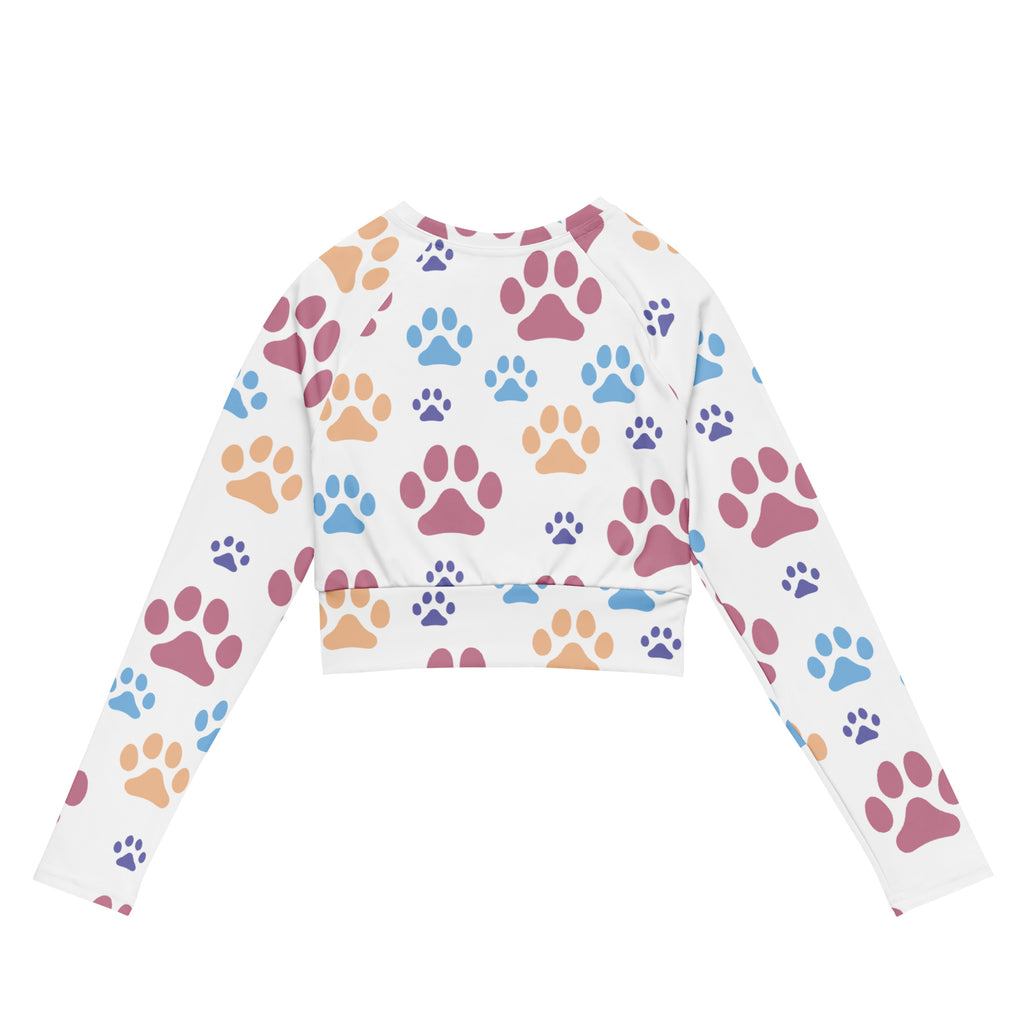 Women’s white long sleeve performance crop top with colorful pink blue and orange paw print pattern