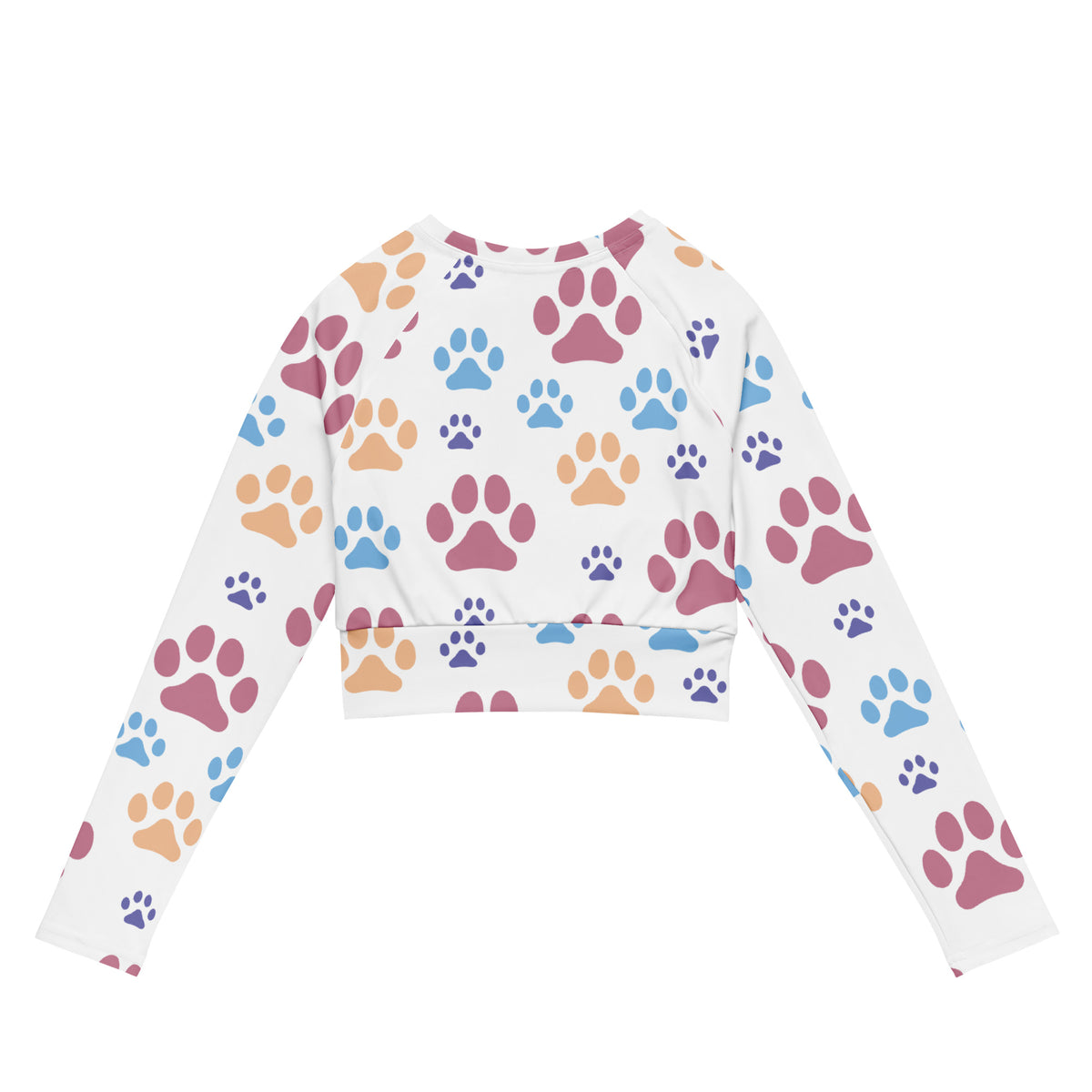 Women’s white long sleeve performance crop top with colorful pink blue and orange paw print pattern