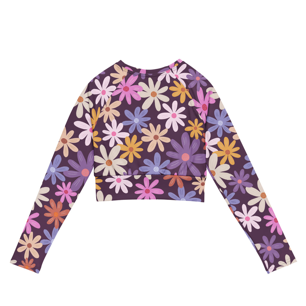 Women’s purple long sleeve performance crop top with vibrant pink yellow blue and white daisy floral pattern