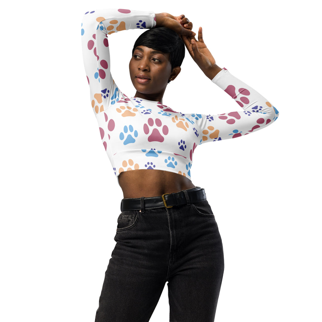 White long-sleeved crop top with colorful blue pink and orange paw print pattern for women performance wear