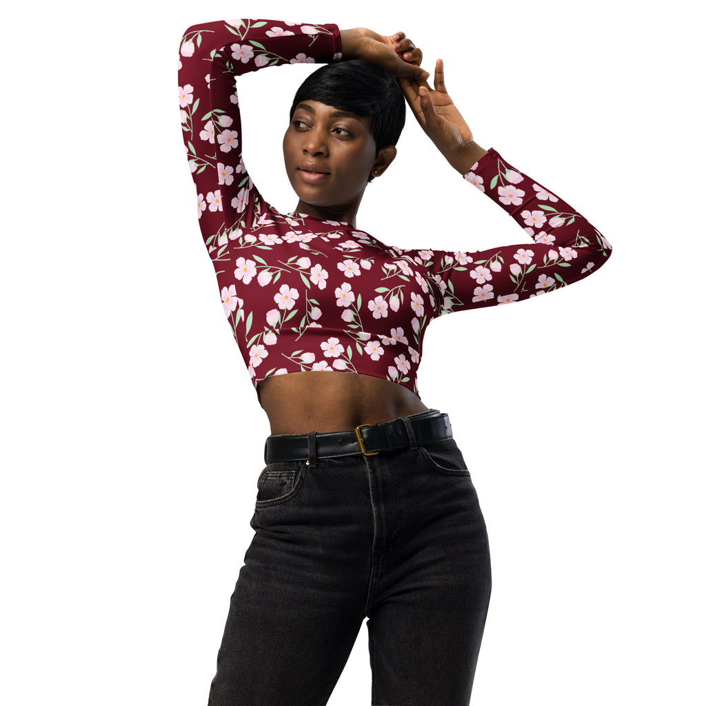 Women’s burgundy floral long sleeve performance crop top with maroon fabric and delicate pink floral pattern
