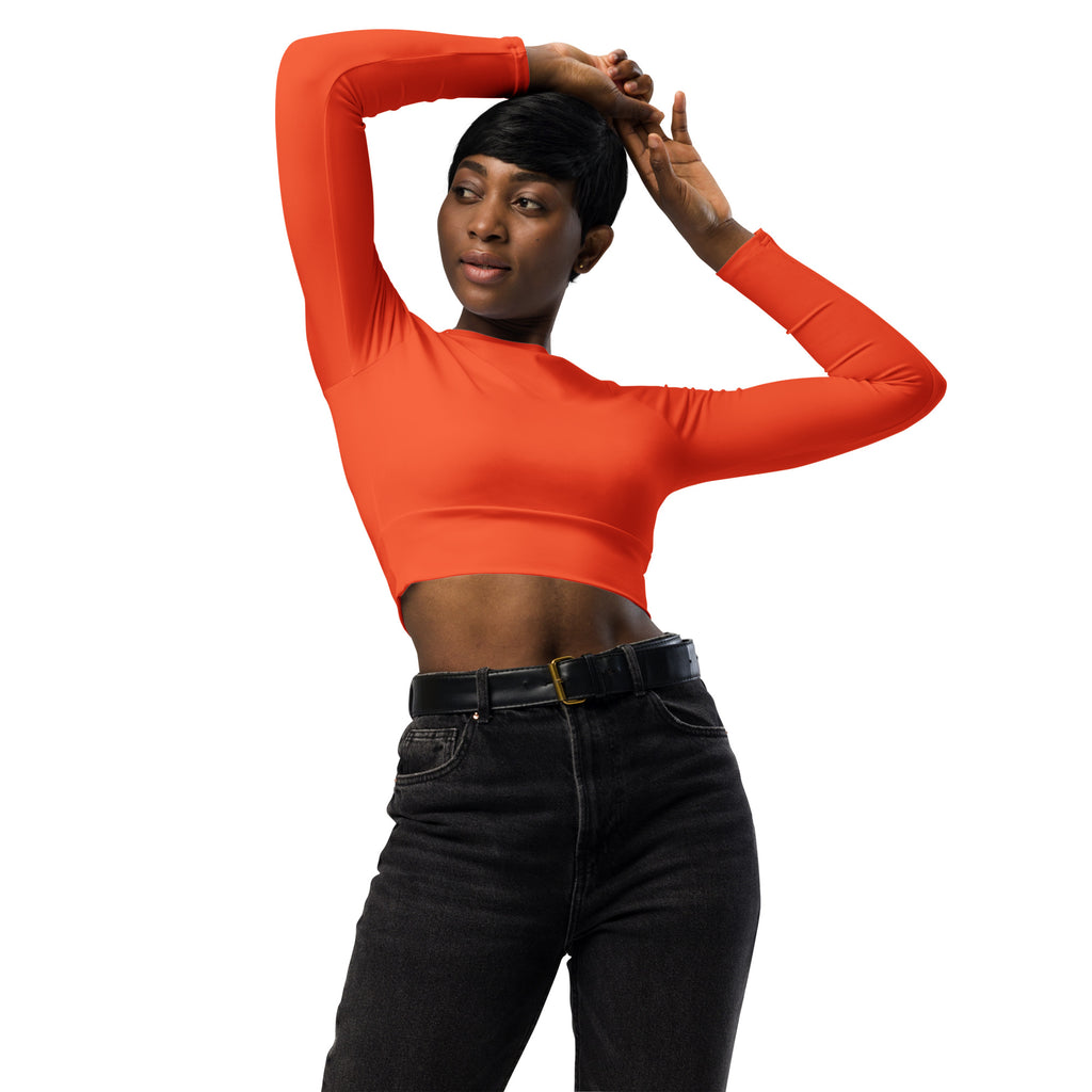 Vibrant orange women’s long sleeve performance crop top with fitted stretchy fabric and high neckline