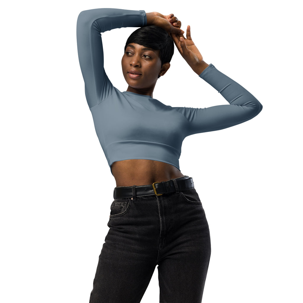 A fitted women’s slate blue long sleeve performance crop top in soft smooth stretchy fabric