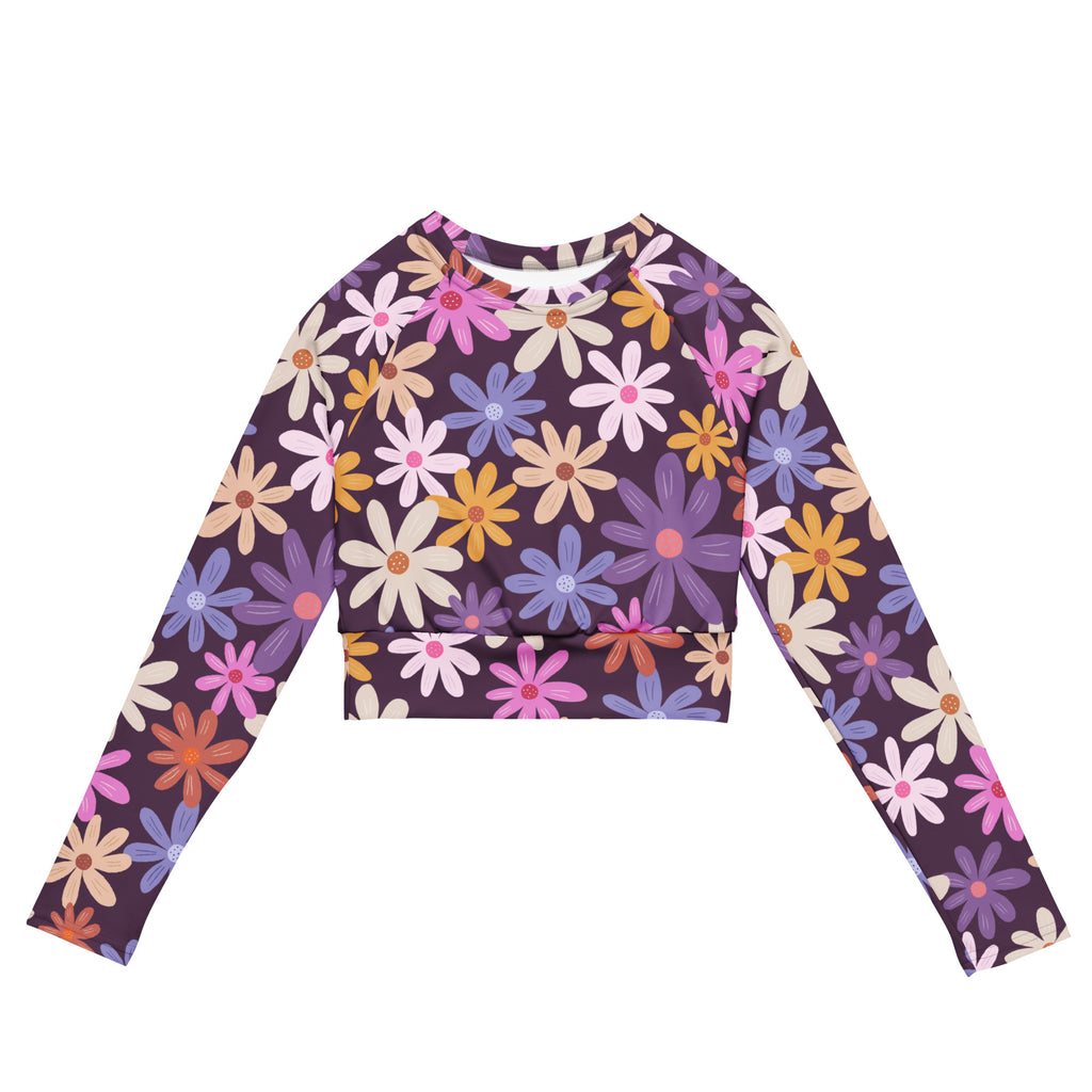 Women’s purple floral long sleeve performance crop top with vibrant pink purple yellow and white daisies on deep purple background