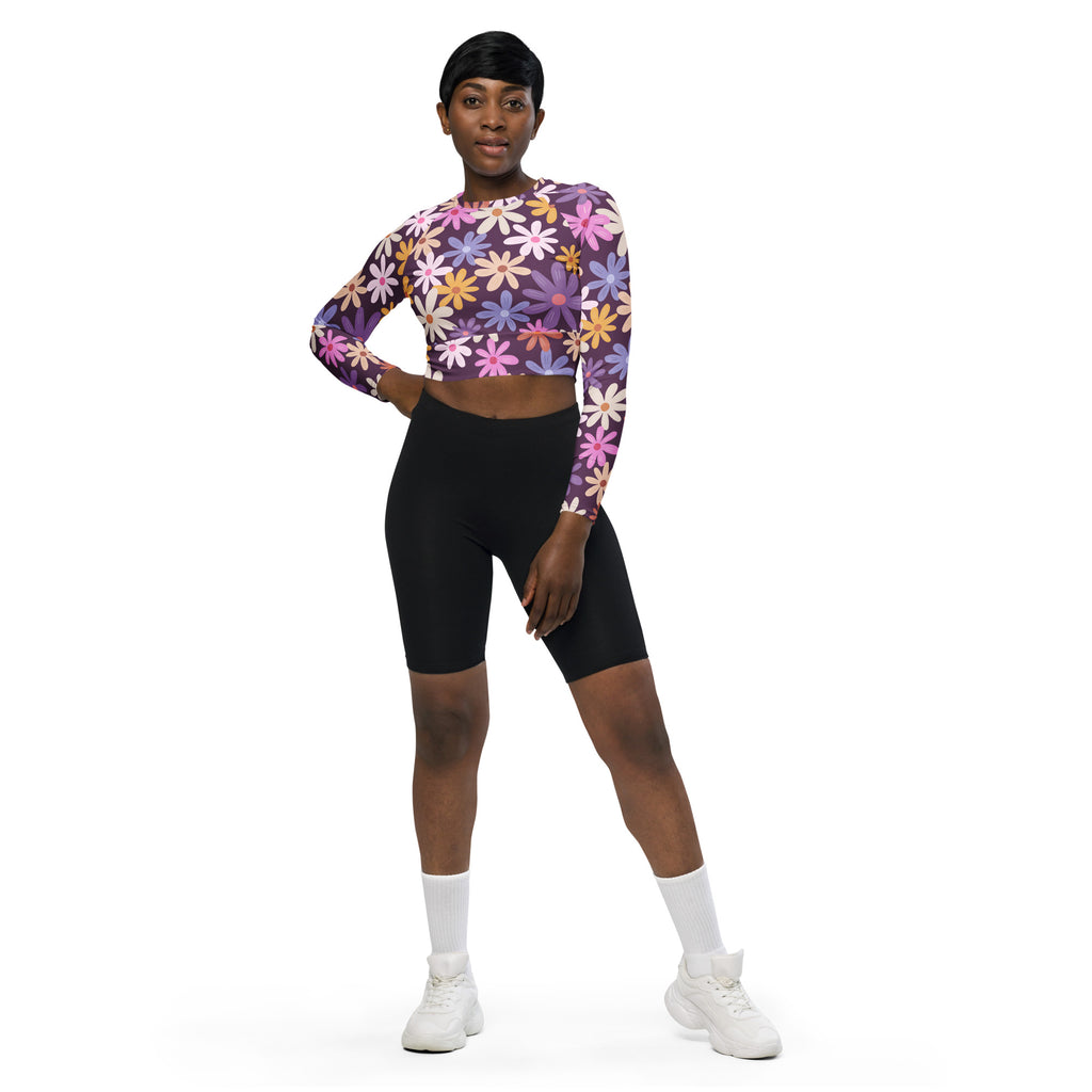 Women’s purple long sleeve performance crop top with vibrant pink yellow and blue floral pattern