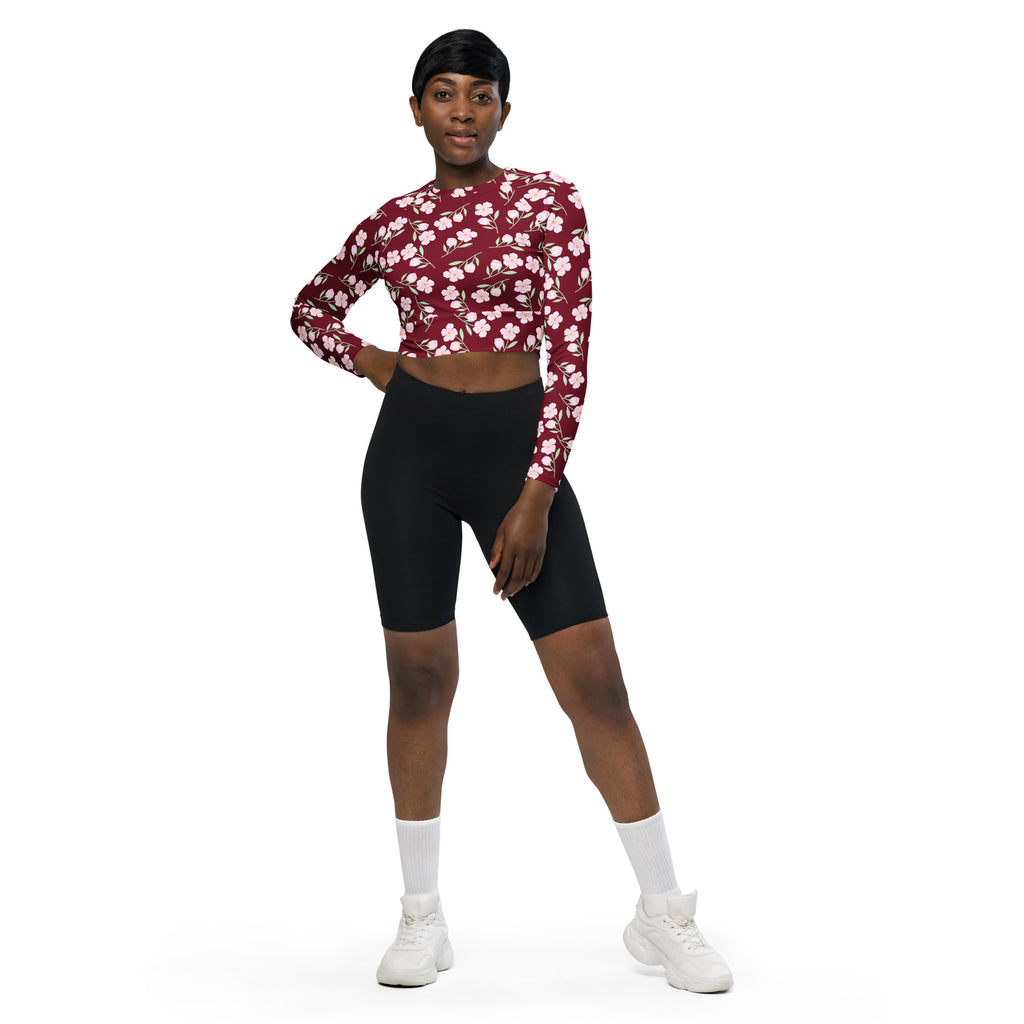 Women’s burgundy floral long sleeve performance crop top with white pattern and breathable fabric for activewear