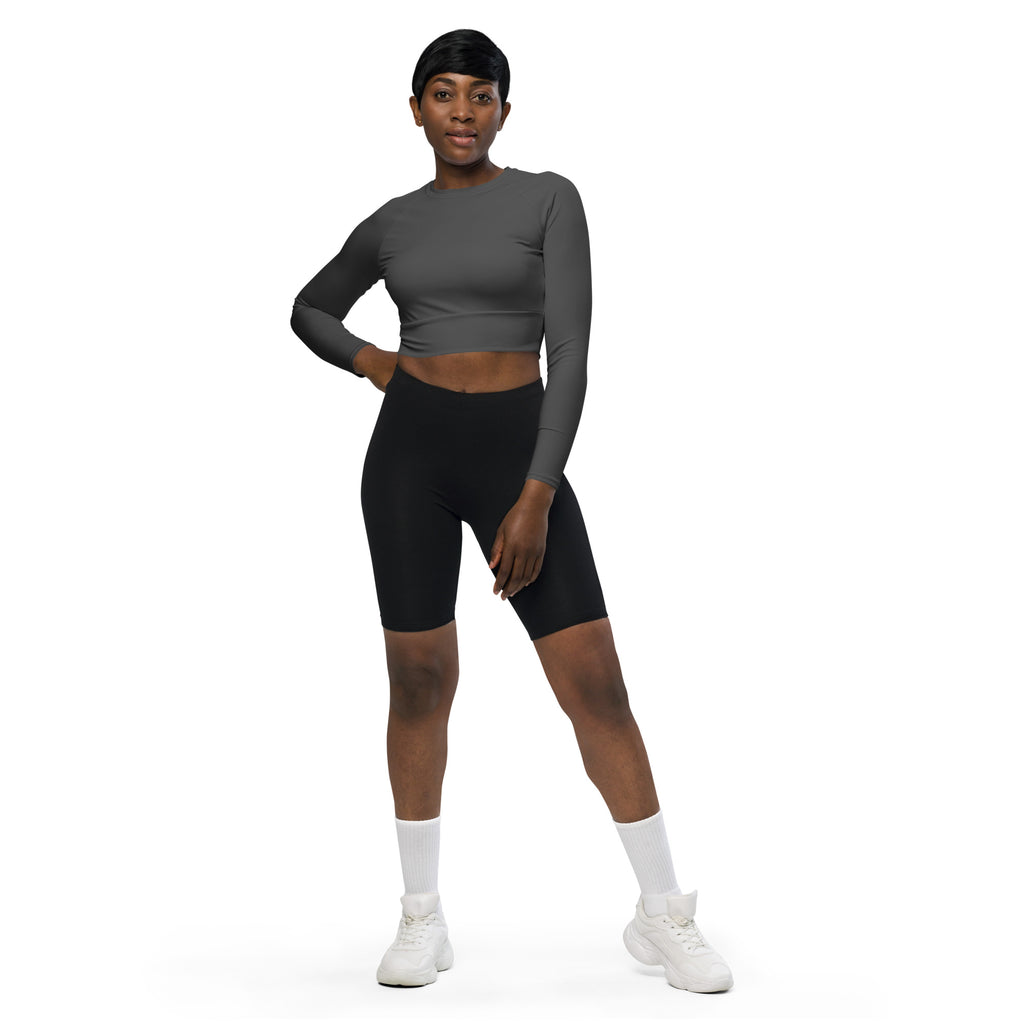 Black biker shorts with smooth form-fitting material and high waistband paired with charcoal long sleeve crop top