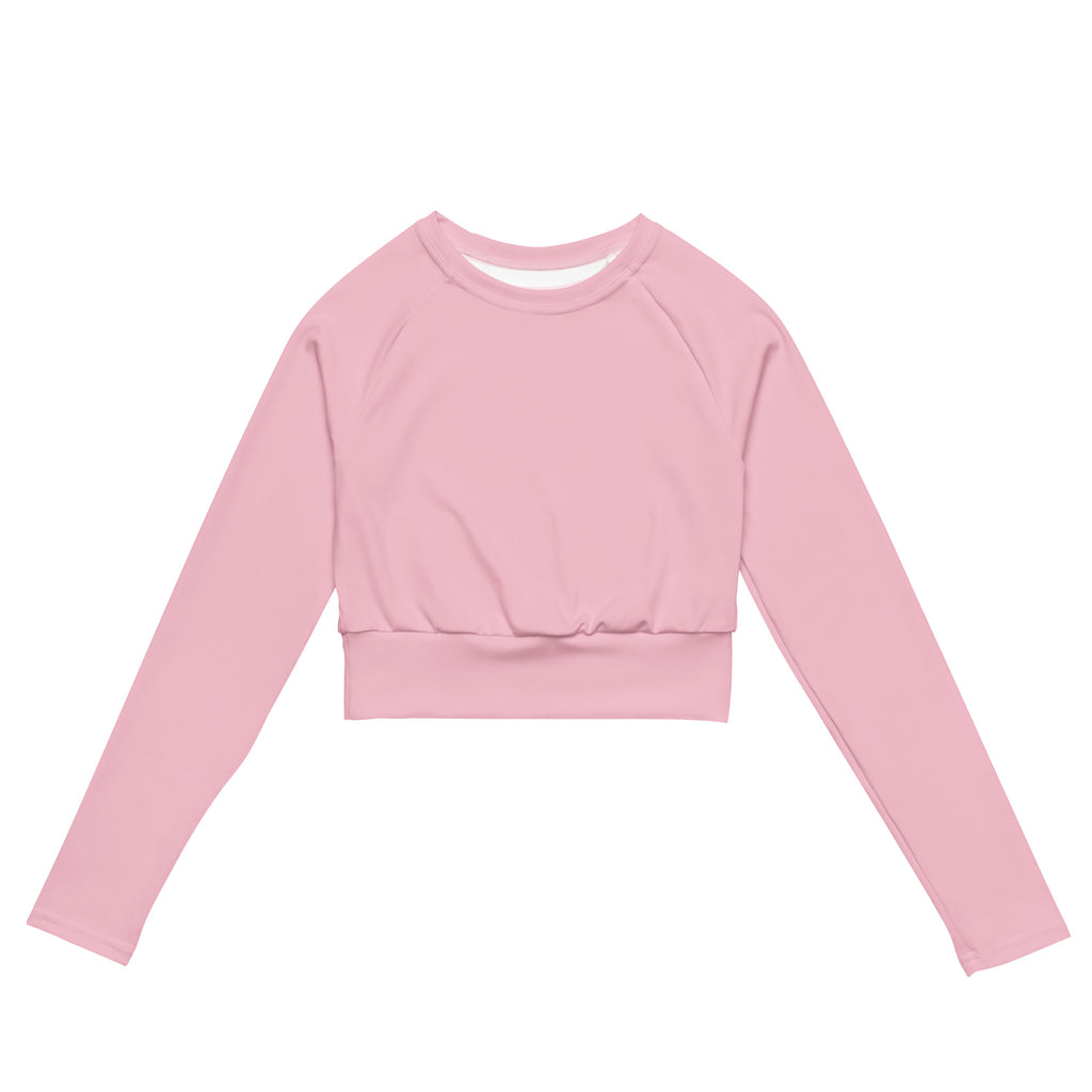 A soft pink long sleeve performance crop top with round neckline and elasticated waistband for women
